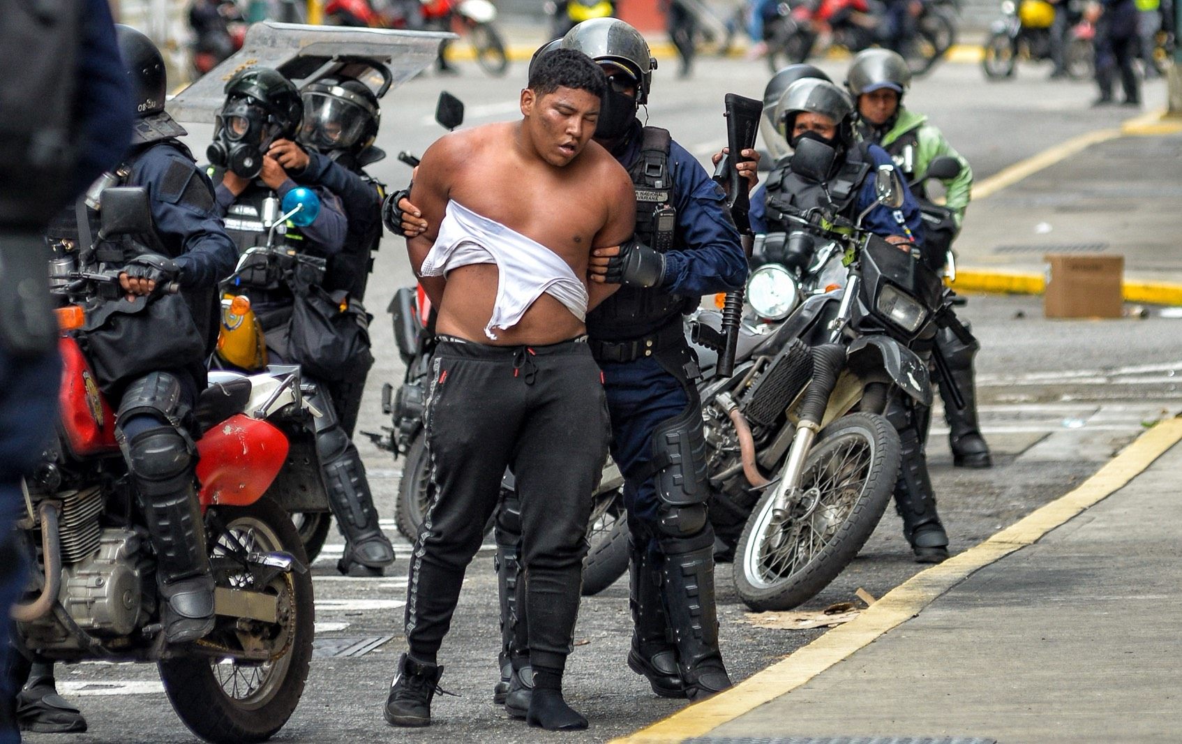 Members of the Bolivarian National police riot squad arresting a man in Caracas, Venezuela last Tuesday. Photo: AFP