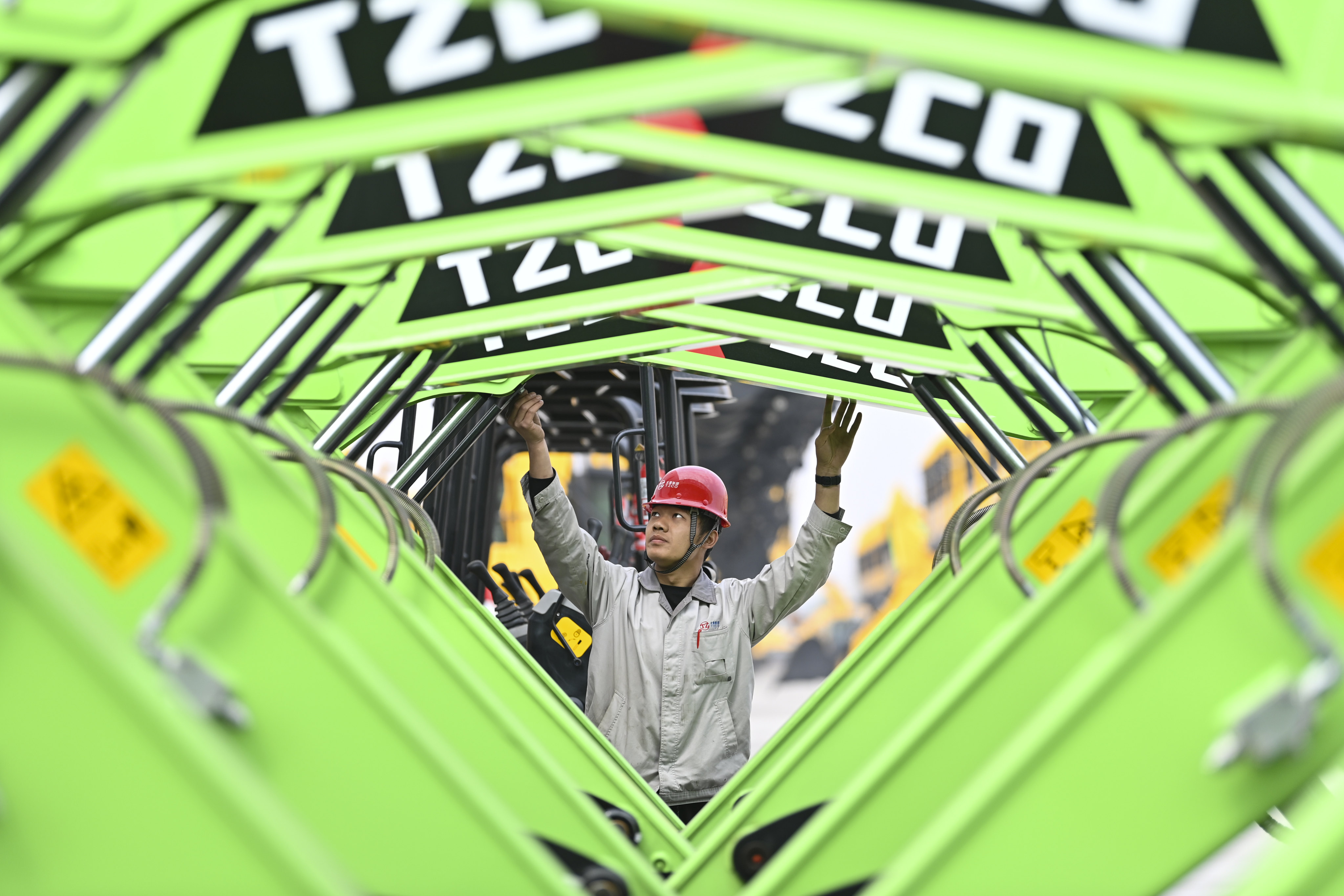 A worker conducts a final inspection on new-energy hydraulic excavators at an industrial park in Taiyuan, Shanxi province, in April. Photo: Xinhua