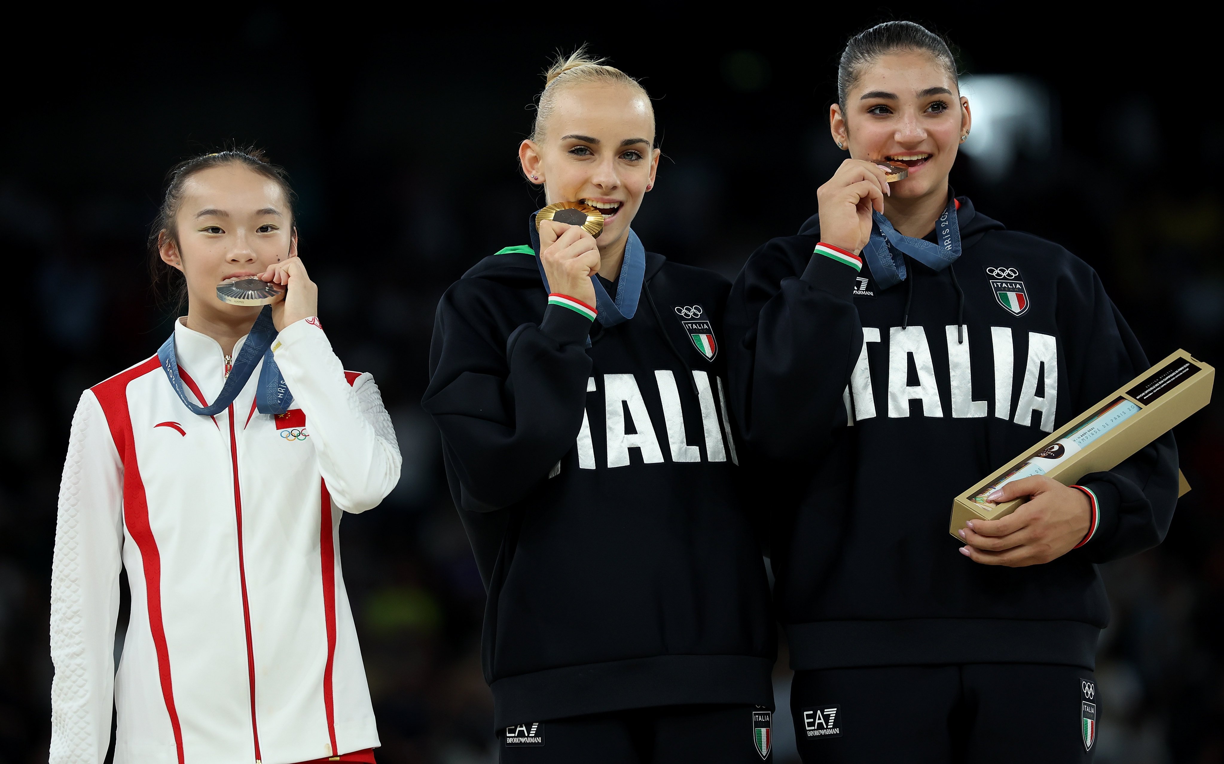 Zhou Yaqin (left), lightly bites her silver medal as she adorably mimics gold medallist Alice D’Amato (centre) and Manila Esposito, who won bronze. Photo: Xinhua