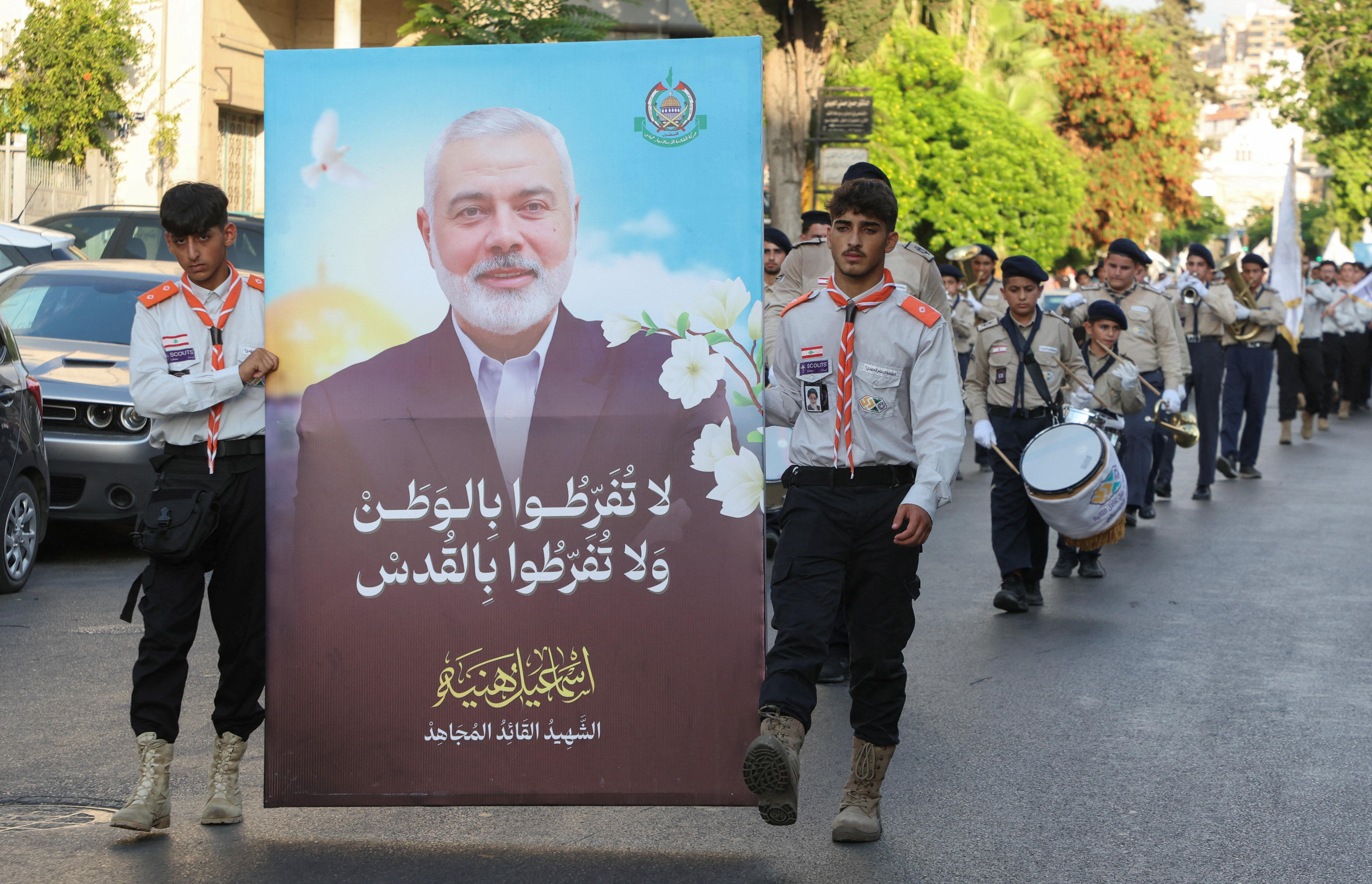 Members of Imam al-Mahdi scouts carry a picture depicting late Hamas leader Ismail Haniyeh during a protest condemning his killing, in Sidon, Lebanon, on Monday. Photo: Reuters