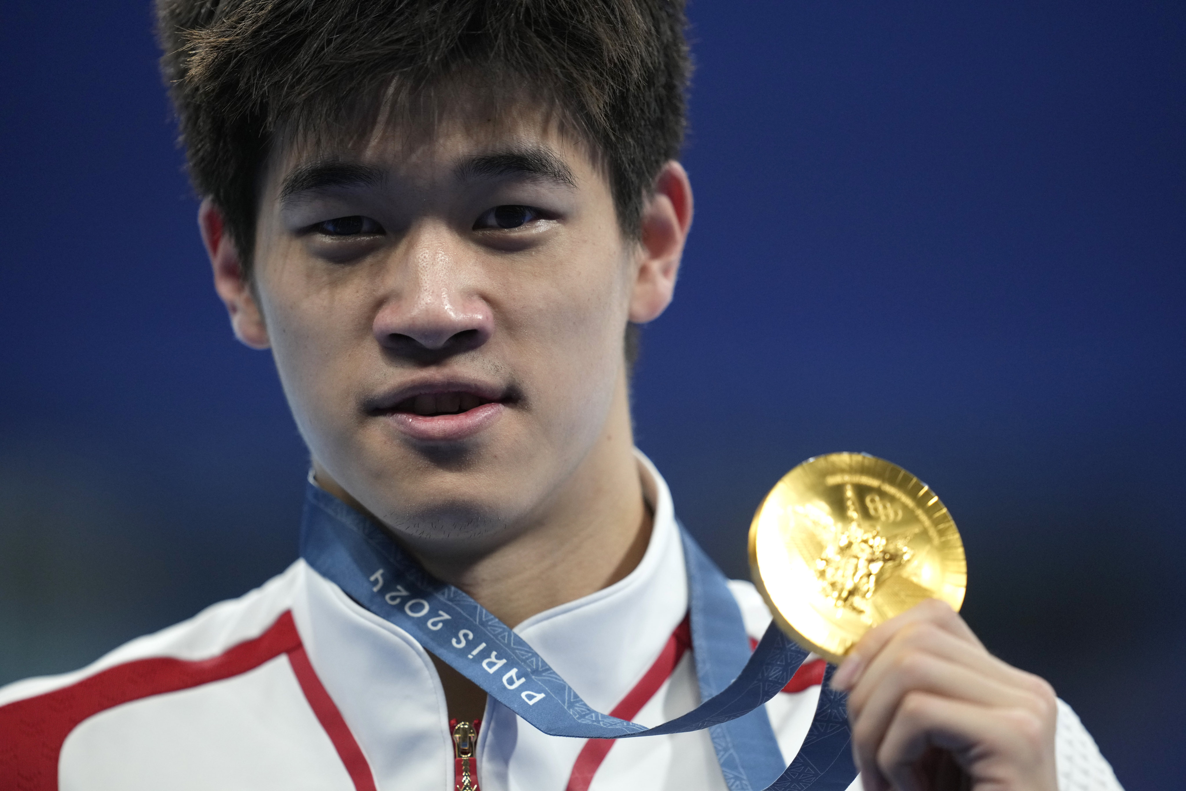 Chinese swimmer Pan Zhanle poses with his gold medal after winning the men’s 100 metre freestyle final at the Paris Olympics. Photo: AP