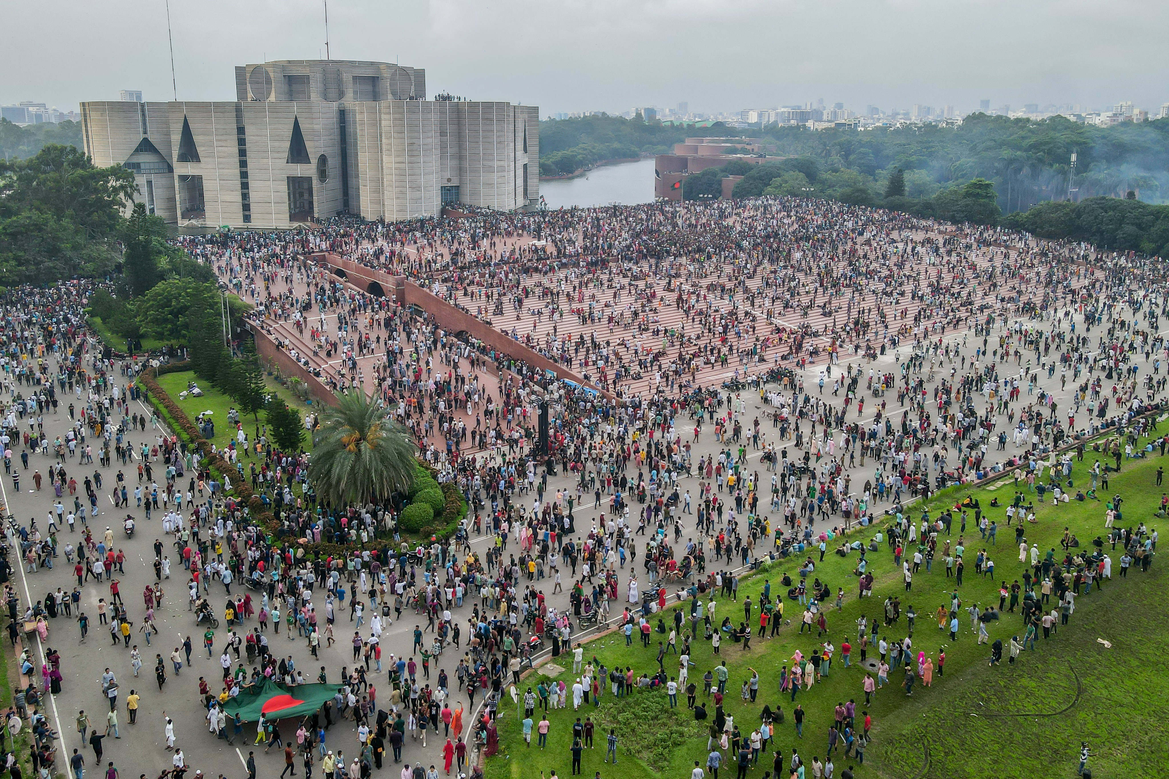 People gather in front of the parliament building on Monday during celebrations after the resignation of Bangladeshi Prime Minister Hasina. Photo: dpa