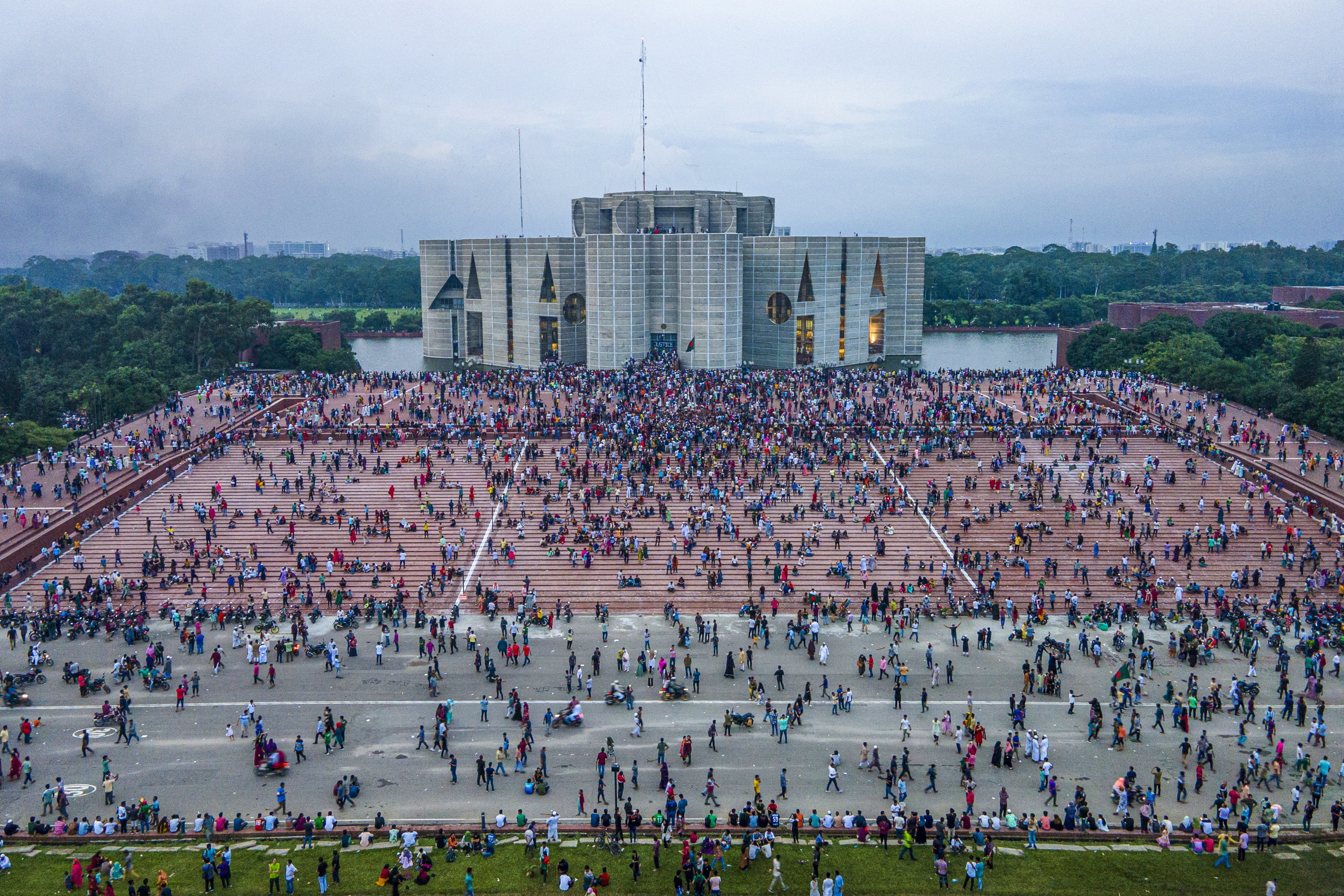 Crowds gather at the Bangladesh Parliament House in Dhaka on Monday. In an address to the nation, Chief of Army Staff General Waker-Uz-Zaman announced that Prime Minister Sheikh Hasina had resigned after weeks of unrest and an interim government would be formed to run the country. Photo: EPA-EFE  