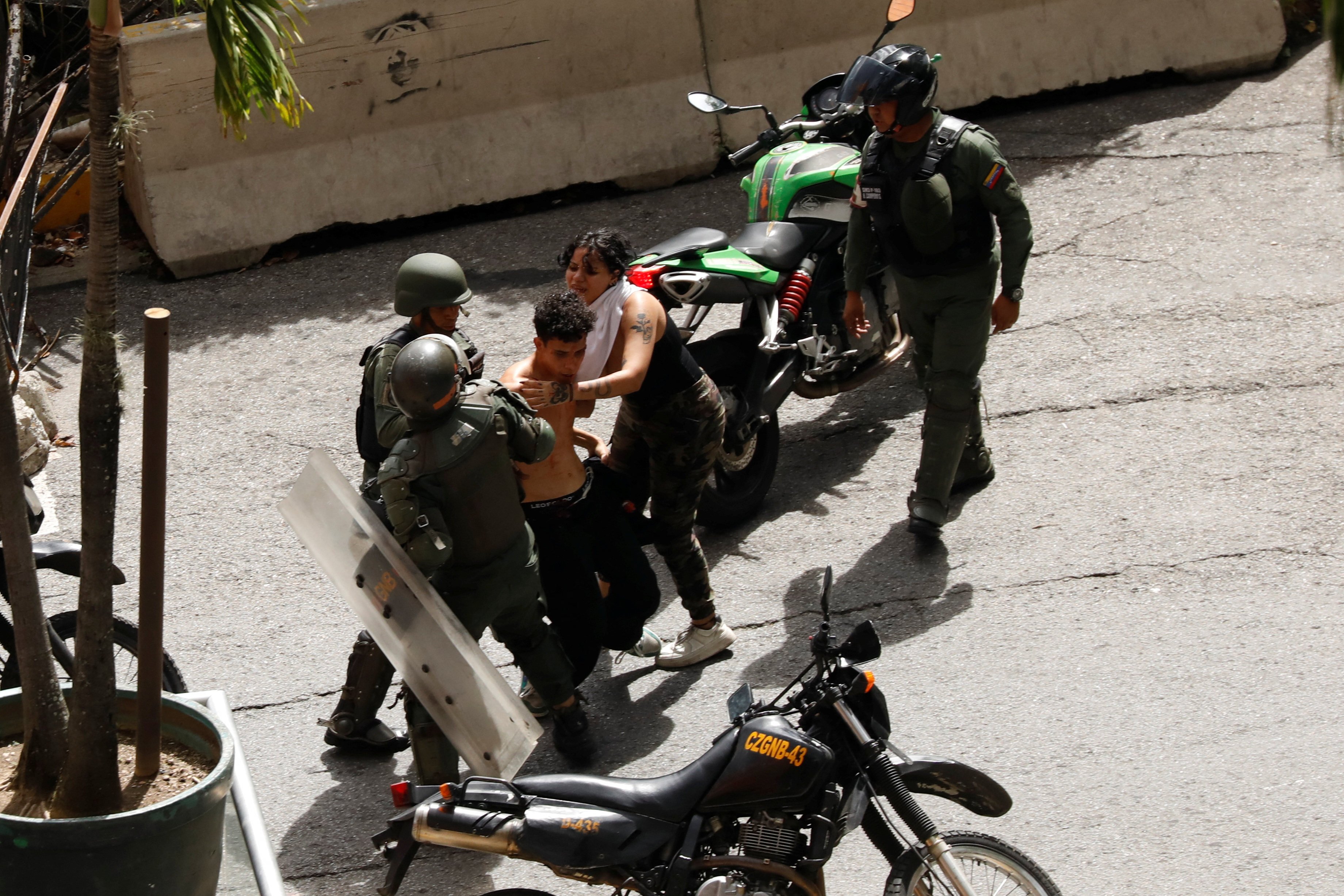 Bolivarian National Guard detain demonstrators during protests in Caracas, Venezuela. Photo: Reuters