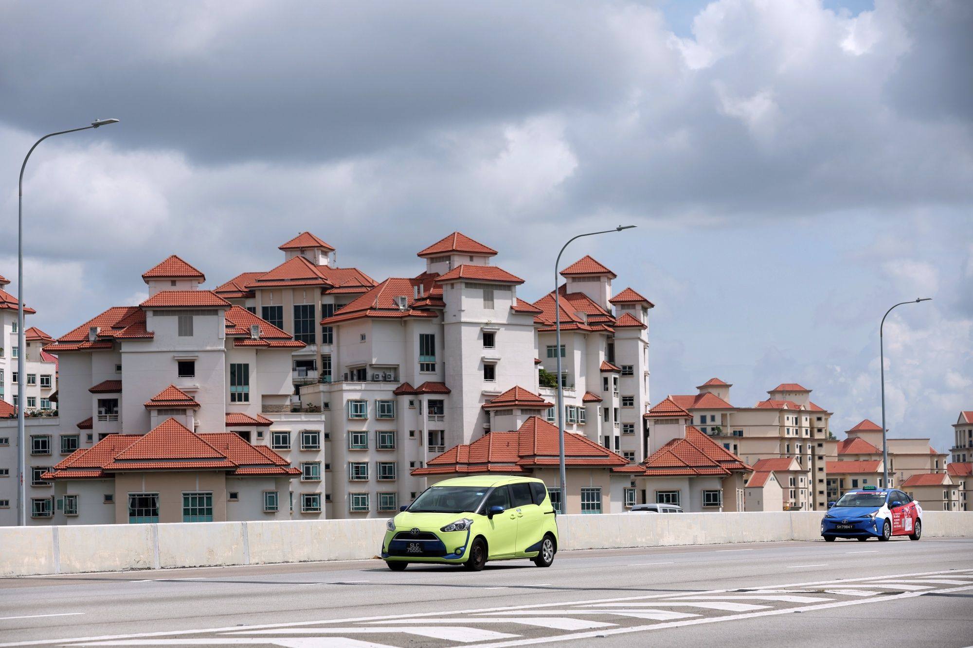 Cars go past residential buildings in Singapore on January 3, 2023. Assessment of the performance of Singapore’s residential property market must devote particular attention to the public housing system. Photo: Bloomberg