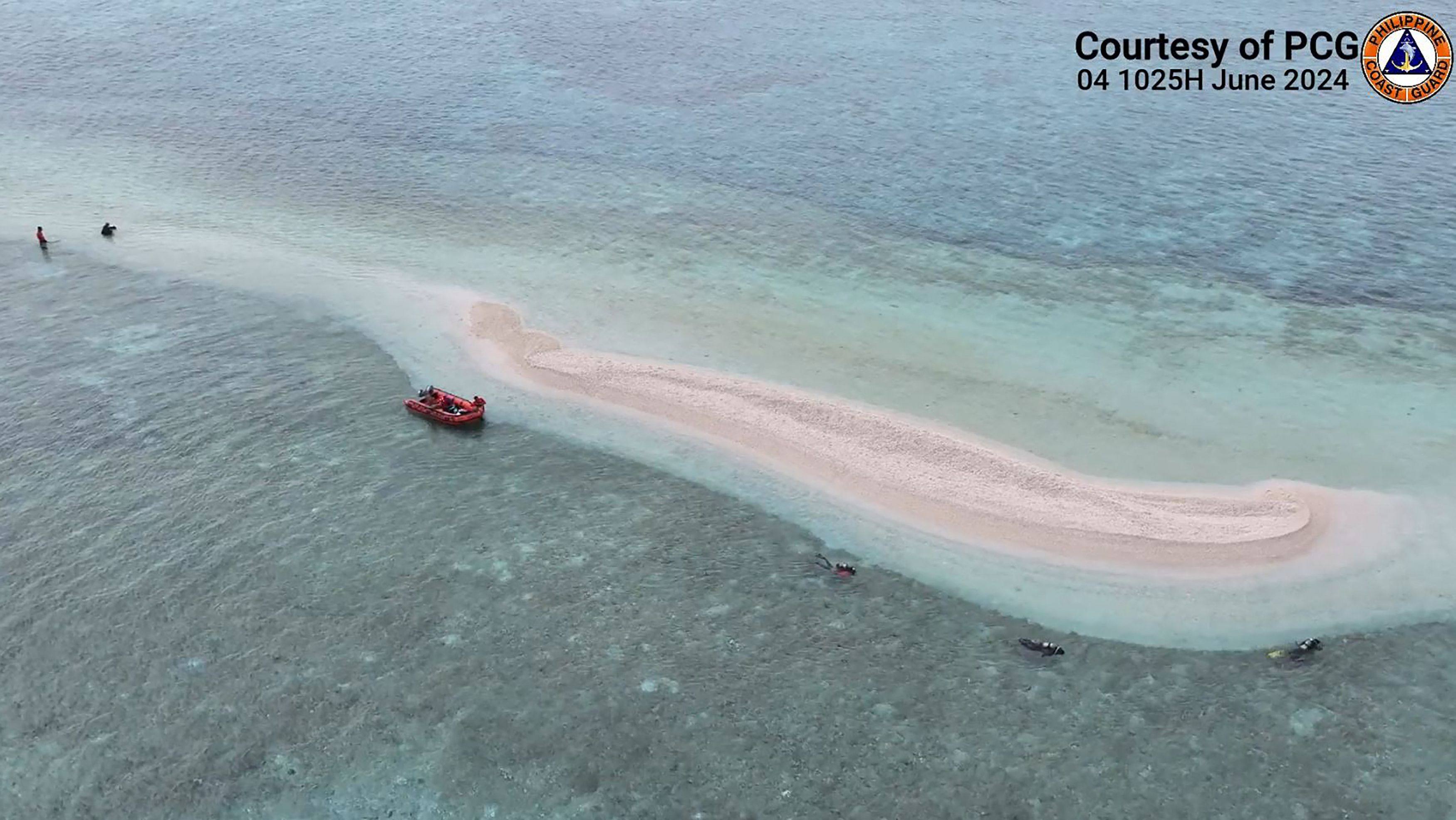 Philippine Coast Guard divers and marine scientists surveying part of Sabina Shoal in the waters of South China Sea in June. Photo: Philippine Coast Guard / AFP