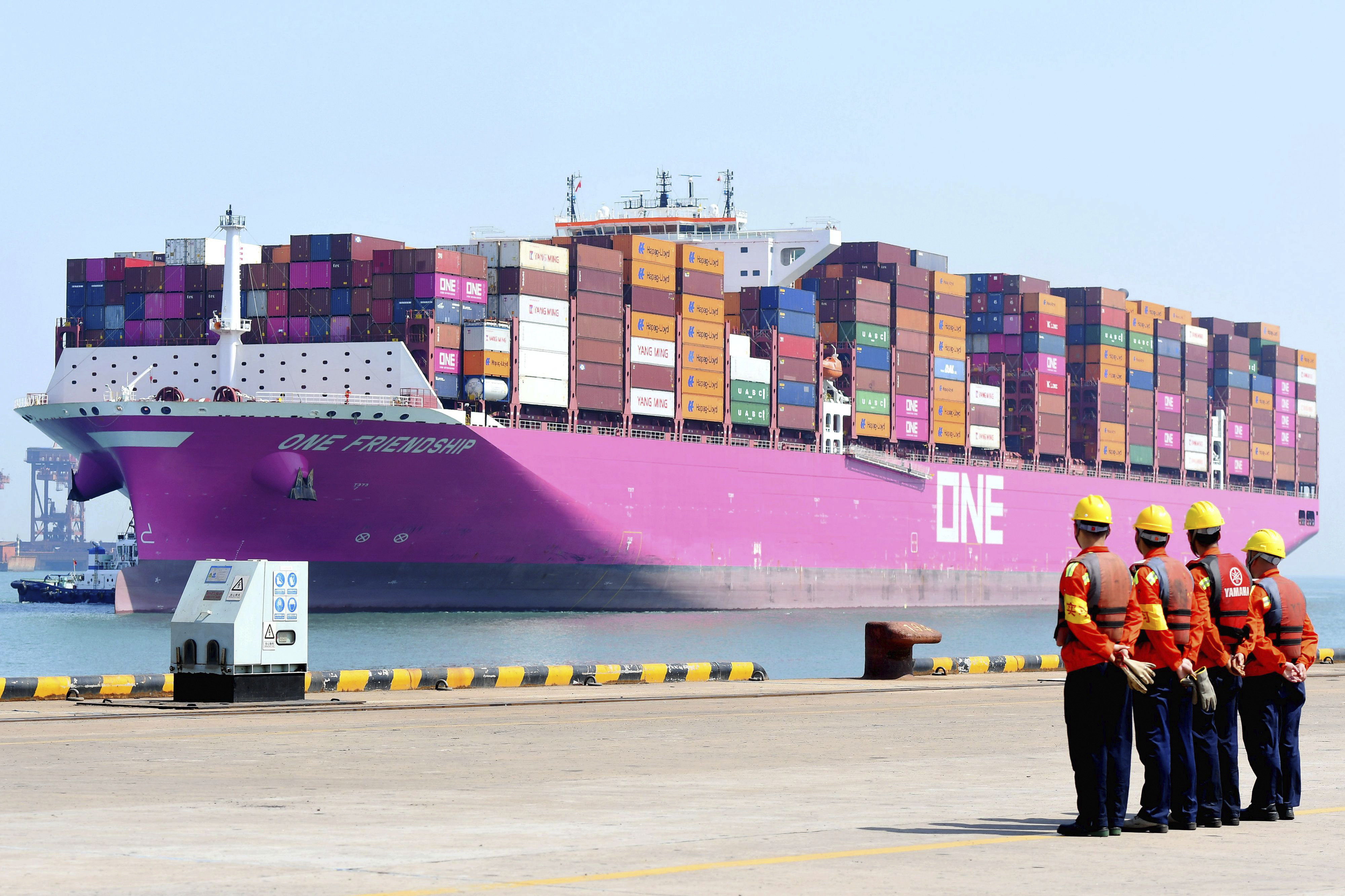 Port workers wait for the arrival of a container ship on a dock in Qingdao in eastern China’s Shandong province. Photo: AP