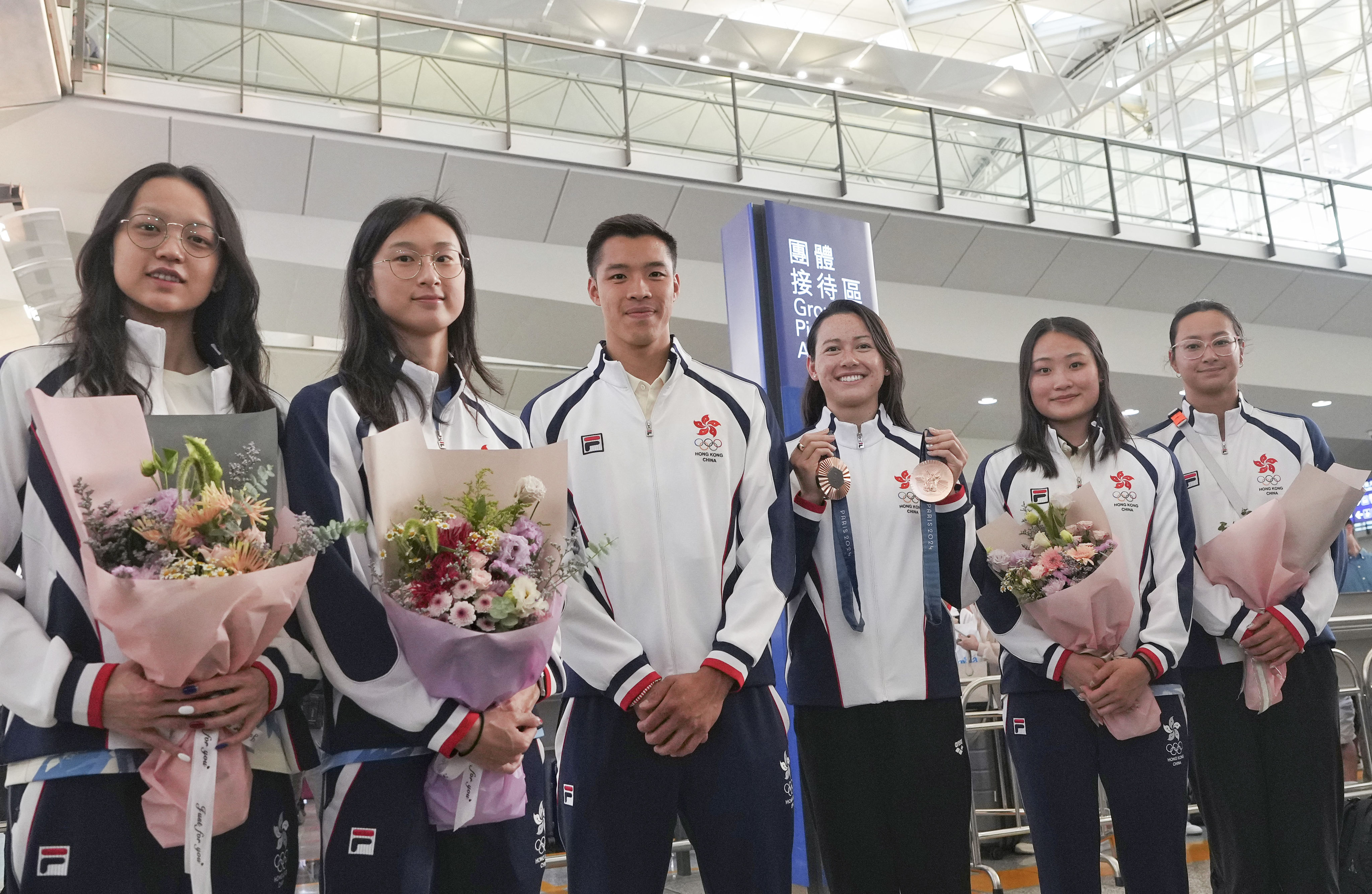 Hong Kong’s Olympic swimming team is seen on Tuesday in Hong Kong International Airport after their participation in the Paris Games. From left to right: Cindy Cheung Sum-yuet, Tam Hoi-lam, Ian Ho Yentou, Siobhan Haughey, Natalie Kan Cheuk-tung, Camille Cheng Lily-mei. Photo: Elson Li