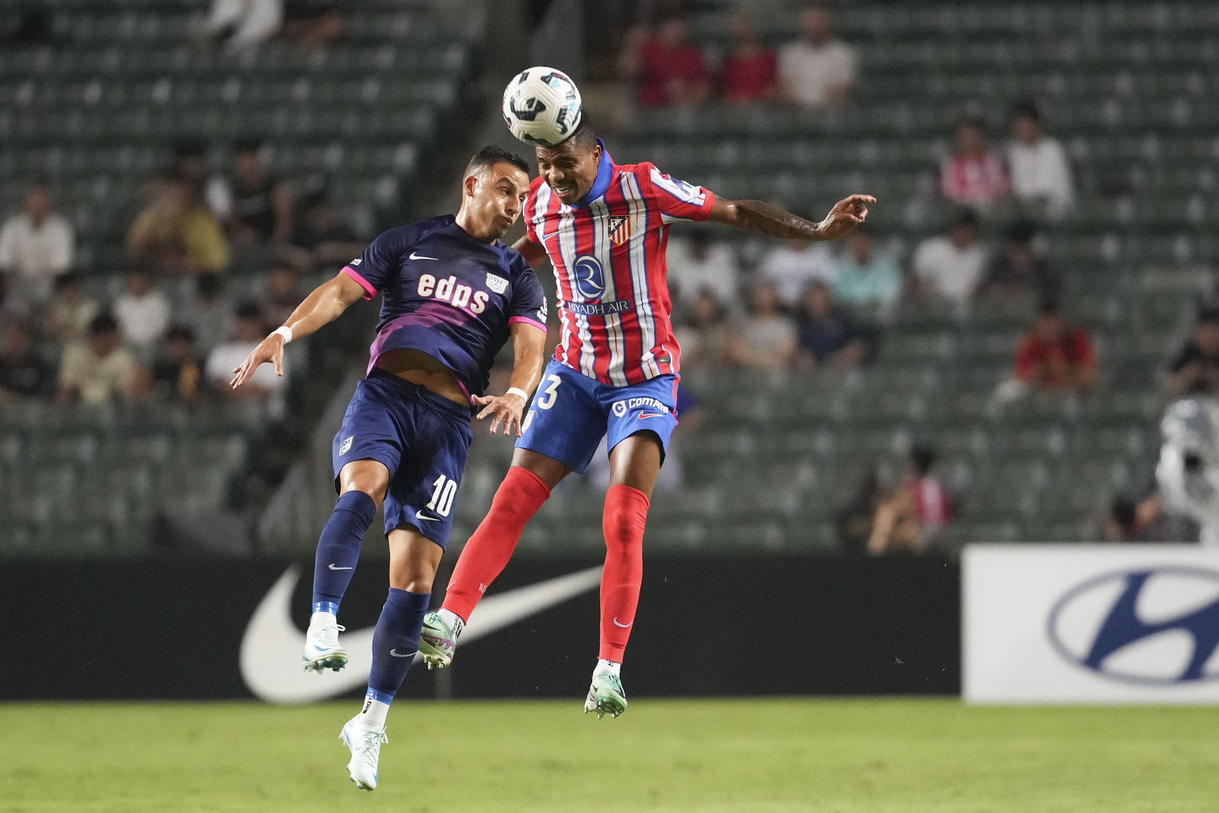 Atletico De Madrid’s Reinildo Mandava (right) and Kitchee’s Luís Machado challenge for the ball during the Boc Life Cup at Hong Kong Stadium. Photo: Sam Tsang