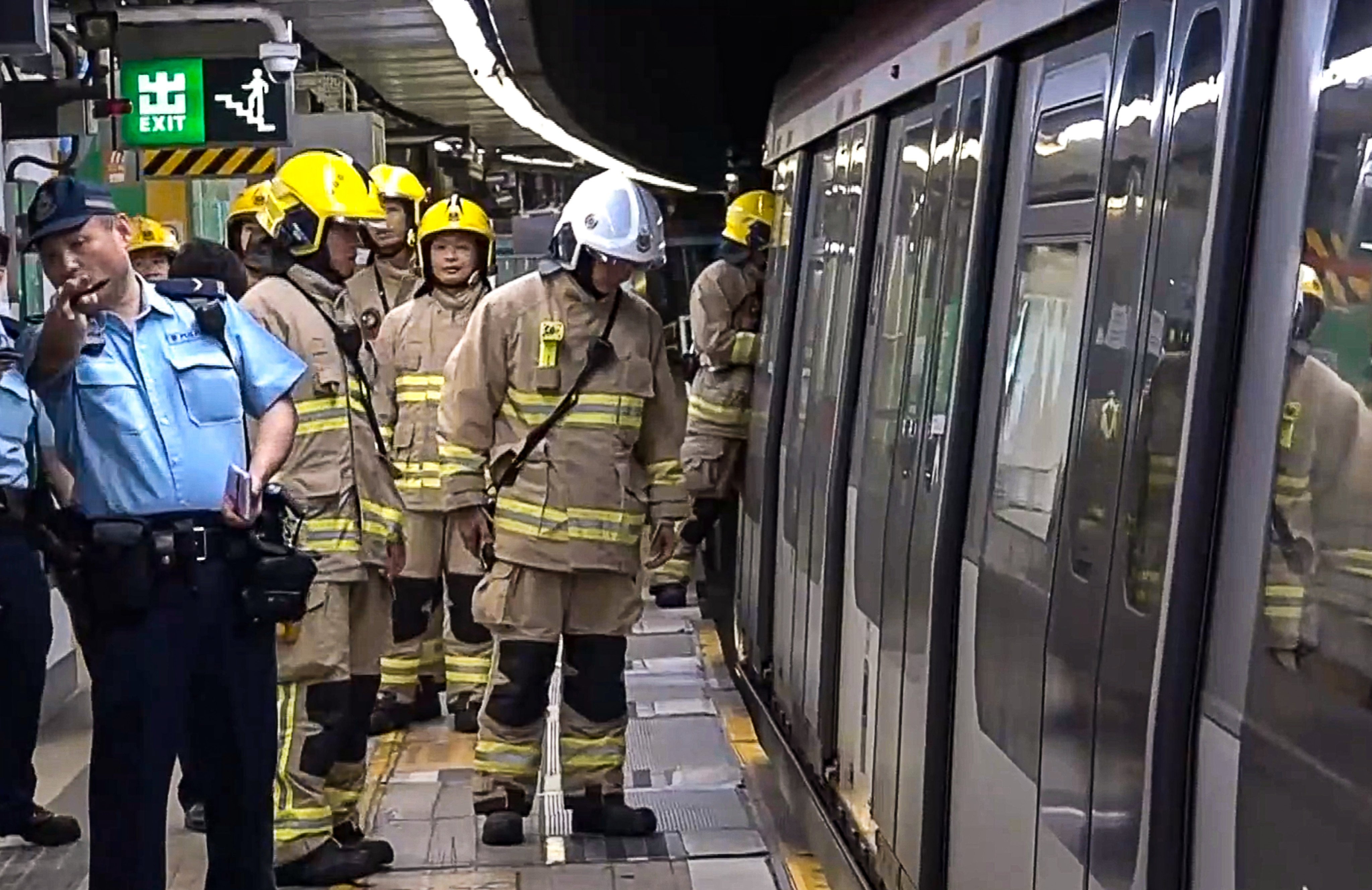 Smoke was seen emerging from underneath a train on Wednesday. Photo: Cable TV