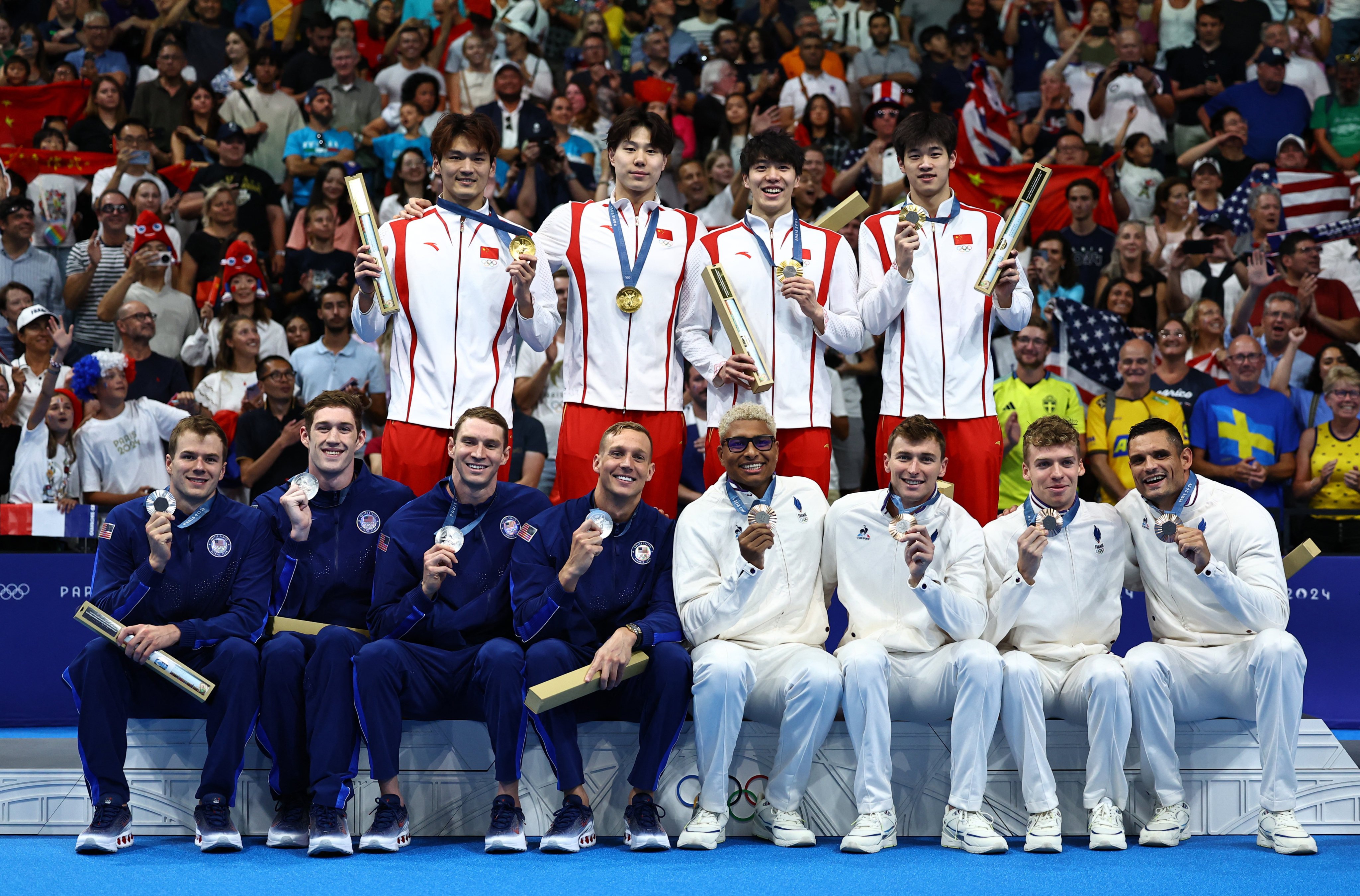 Swimmers from China, the USA and France pose with their medals after the men’s 4x100m medley relay at Paris La Defense Arena. Photo: Reuters