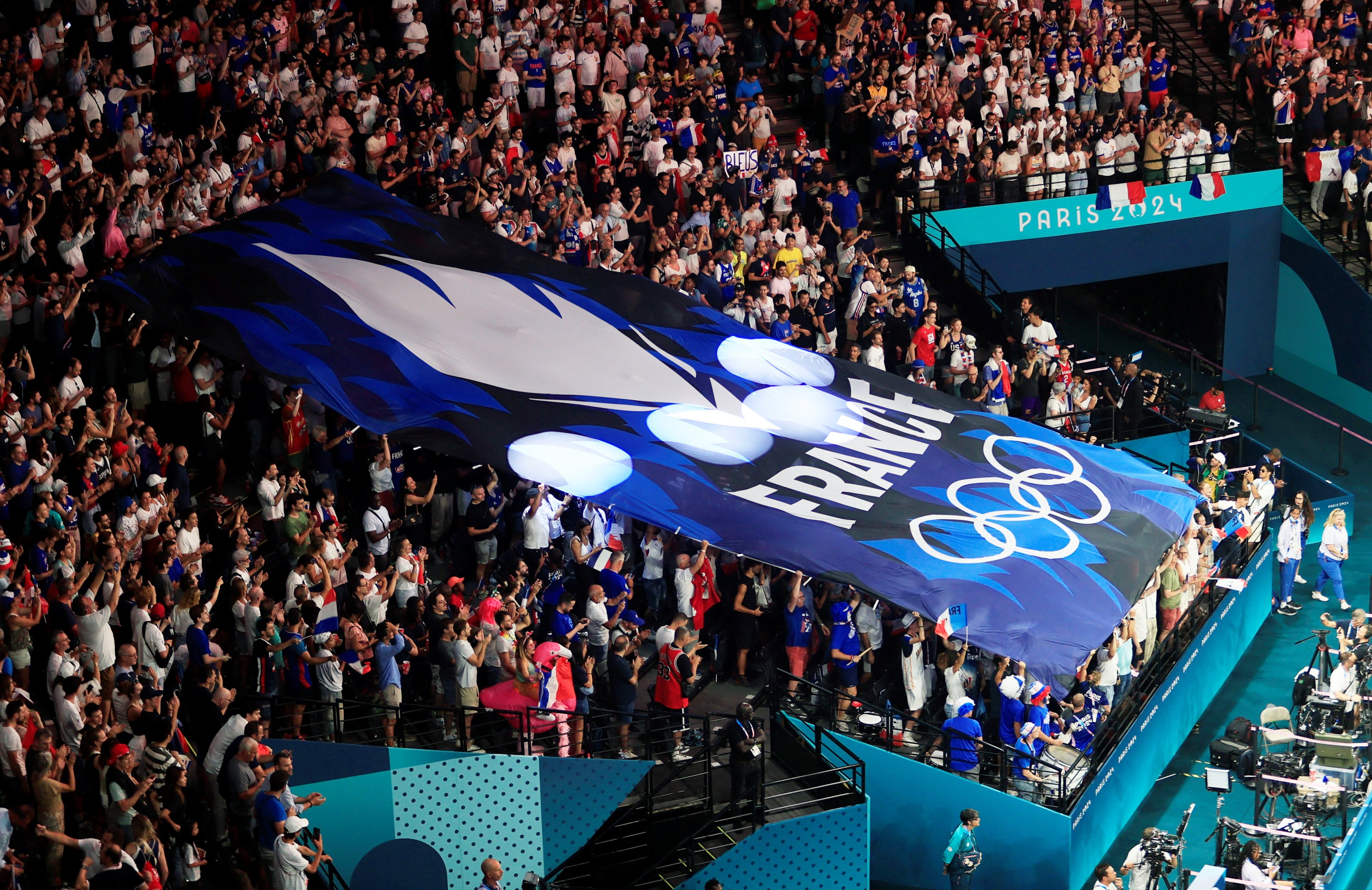 French fans show their support as their team take on Canada in the basketball men’s quarterfinal on Tuesday. Photo: Reuters