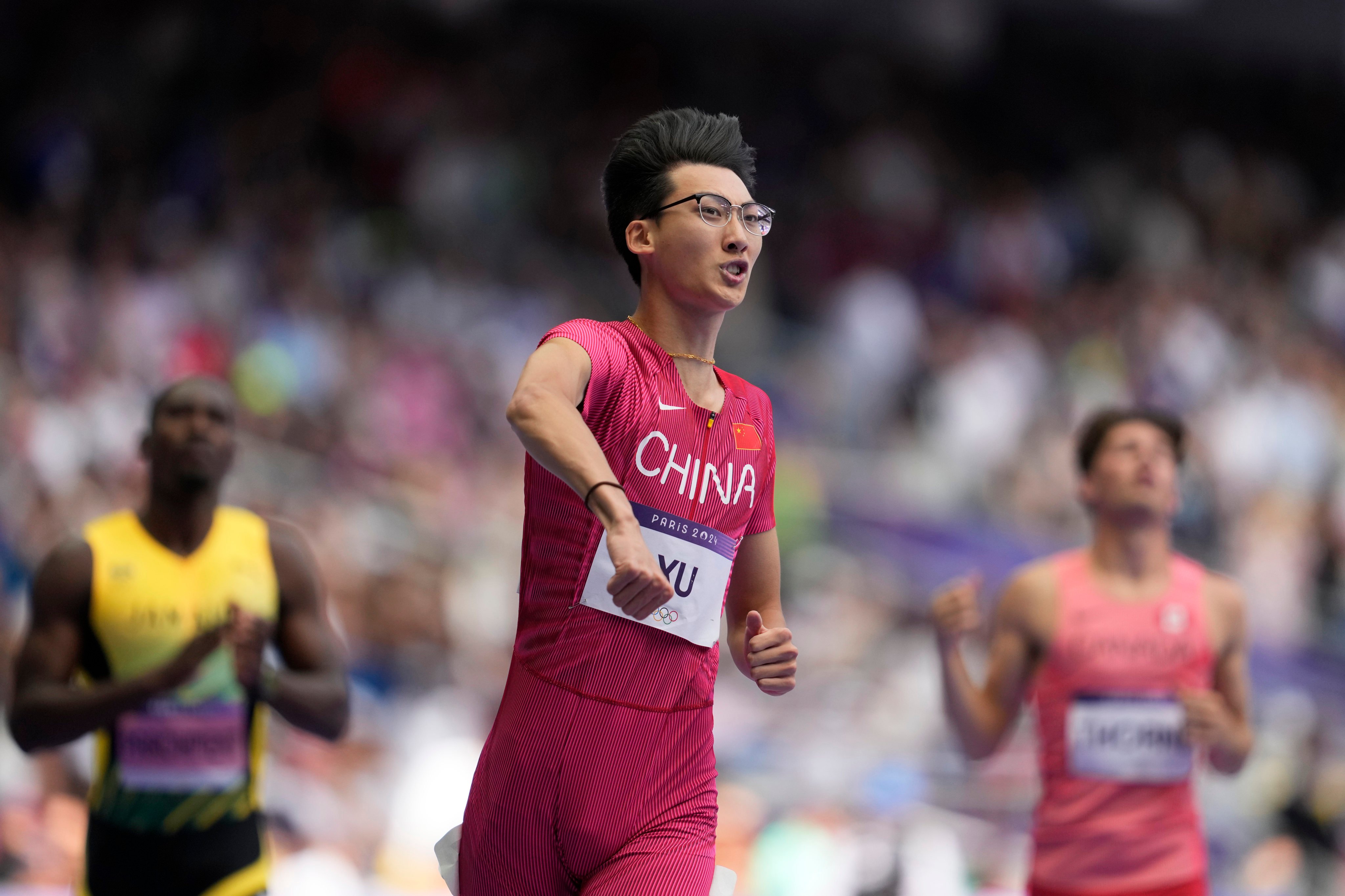 Xu Zhuoyi celebrates after winning his heat in qualifying for the men’s 110m hurdles semi-finals. Photo: AP