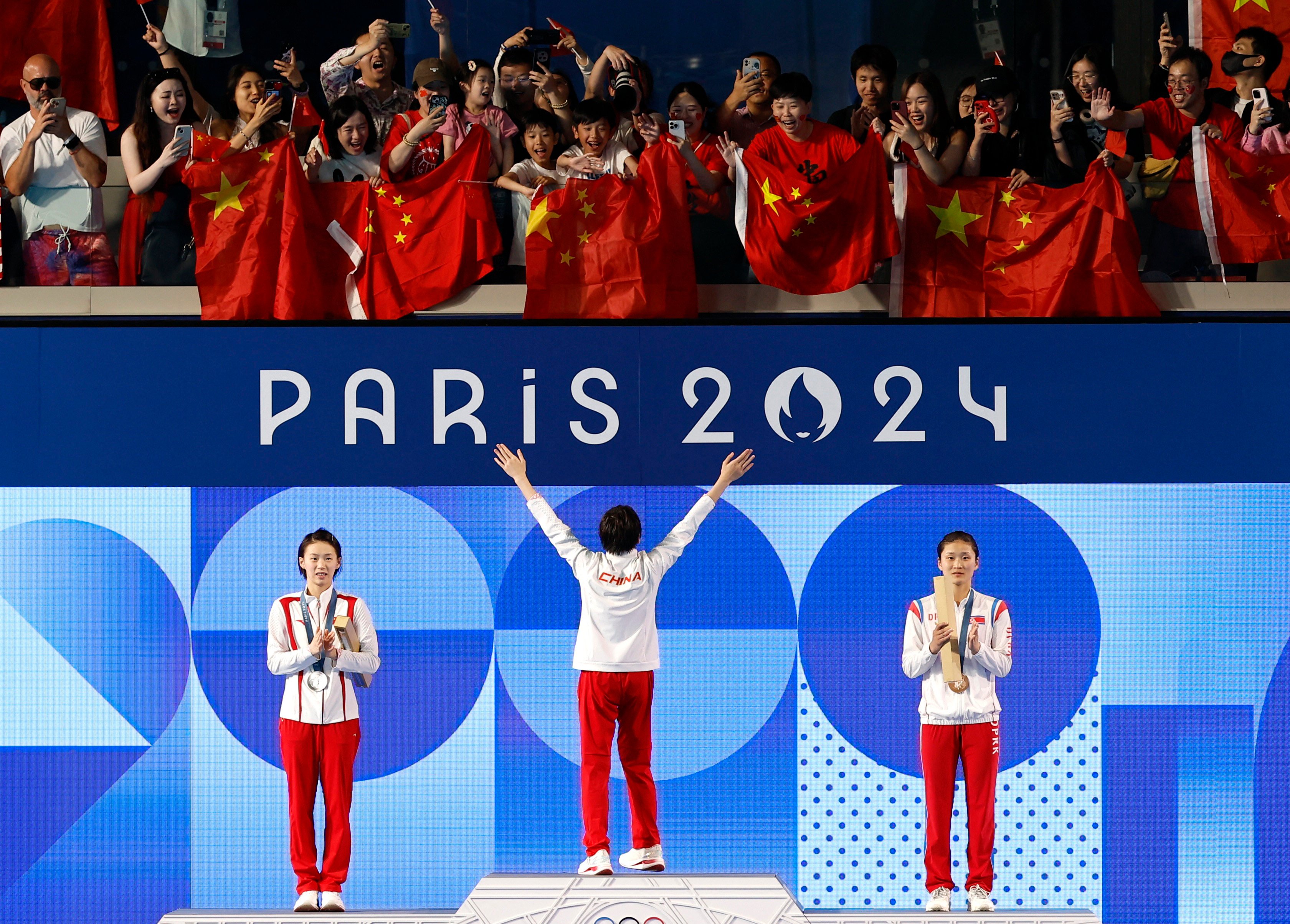 Gold medallist Quan Hongchan celebrates on the podium with silver medallist Yuxi Chen (left) and bronze medallist Mi Rae-kim of North Korea after winning the women’s 10m platform. Photo: Reuters