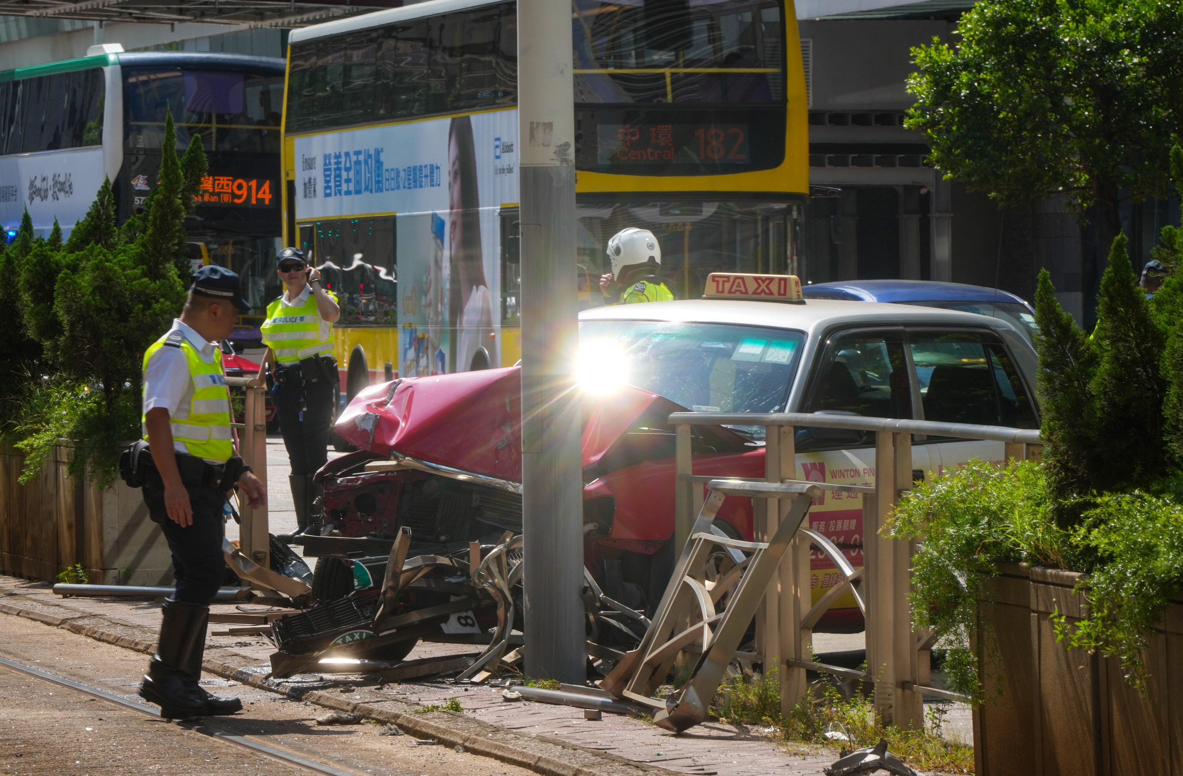 Two men have been injured after a taxi crashed into a lamp post. Photo: Sam Tsang