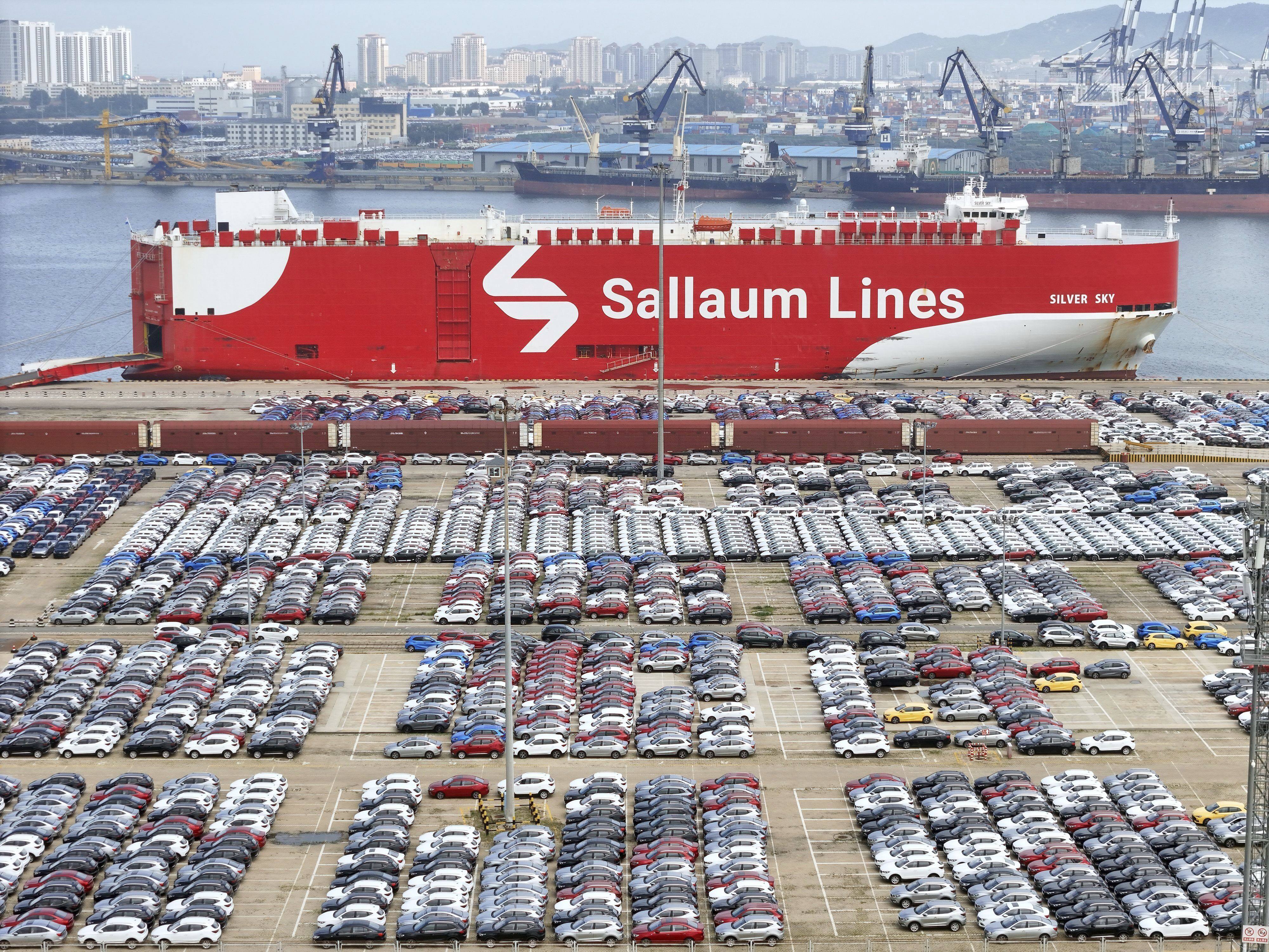 New cars wait for transportation near a Sallaum Lines ro-ro ship seen by the dock in Yantai in east China’s Shandong province. Photo: AP