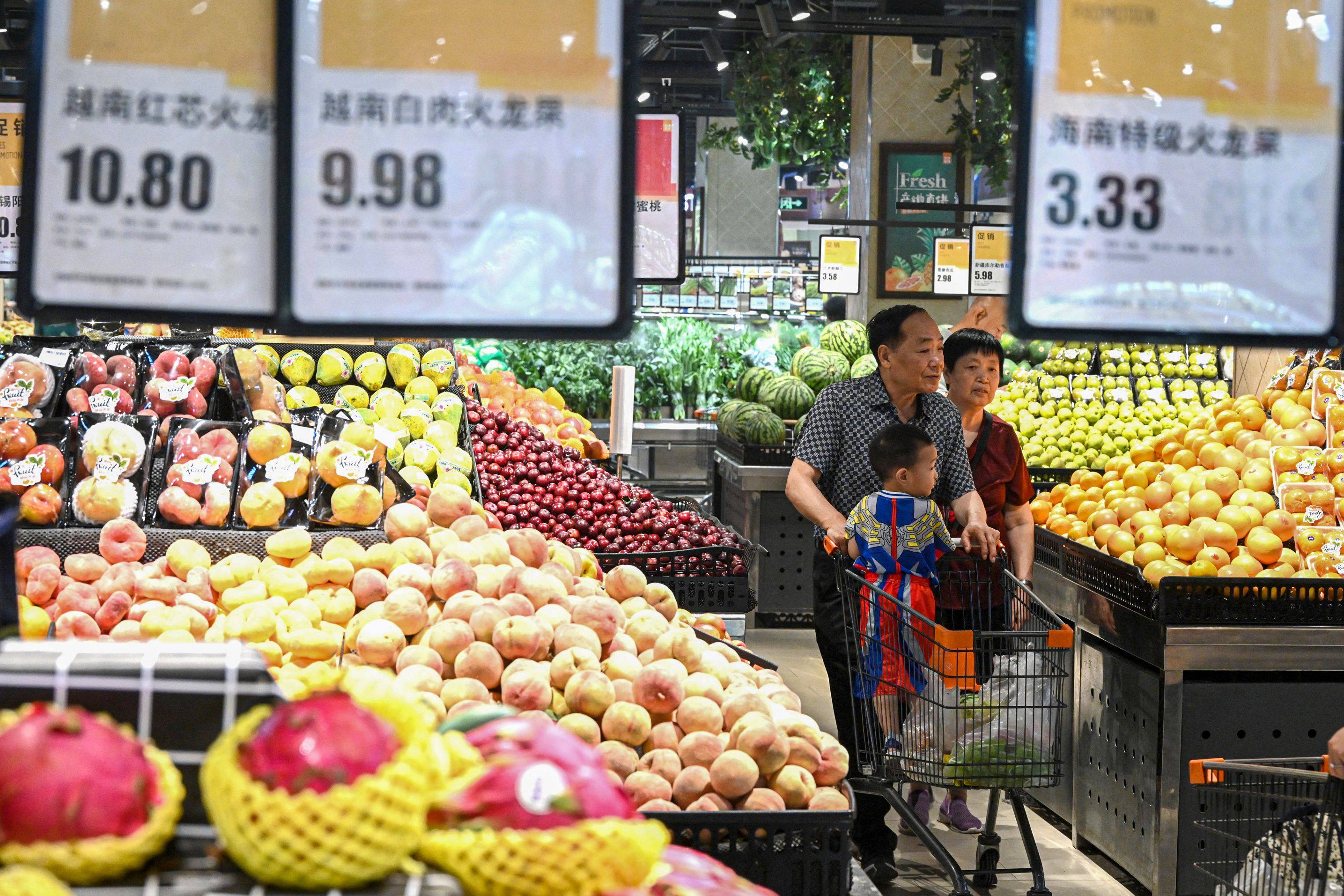 People shop for fruits and vegetables at a supermarket in Handan, in northern China’s Hebei province. Photo: AFP