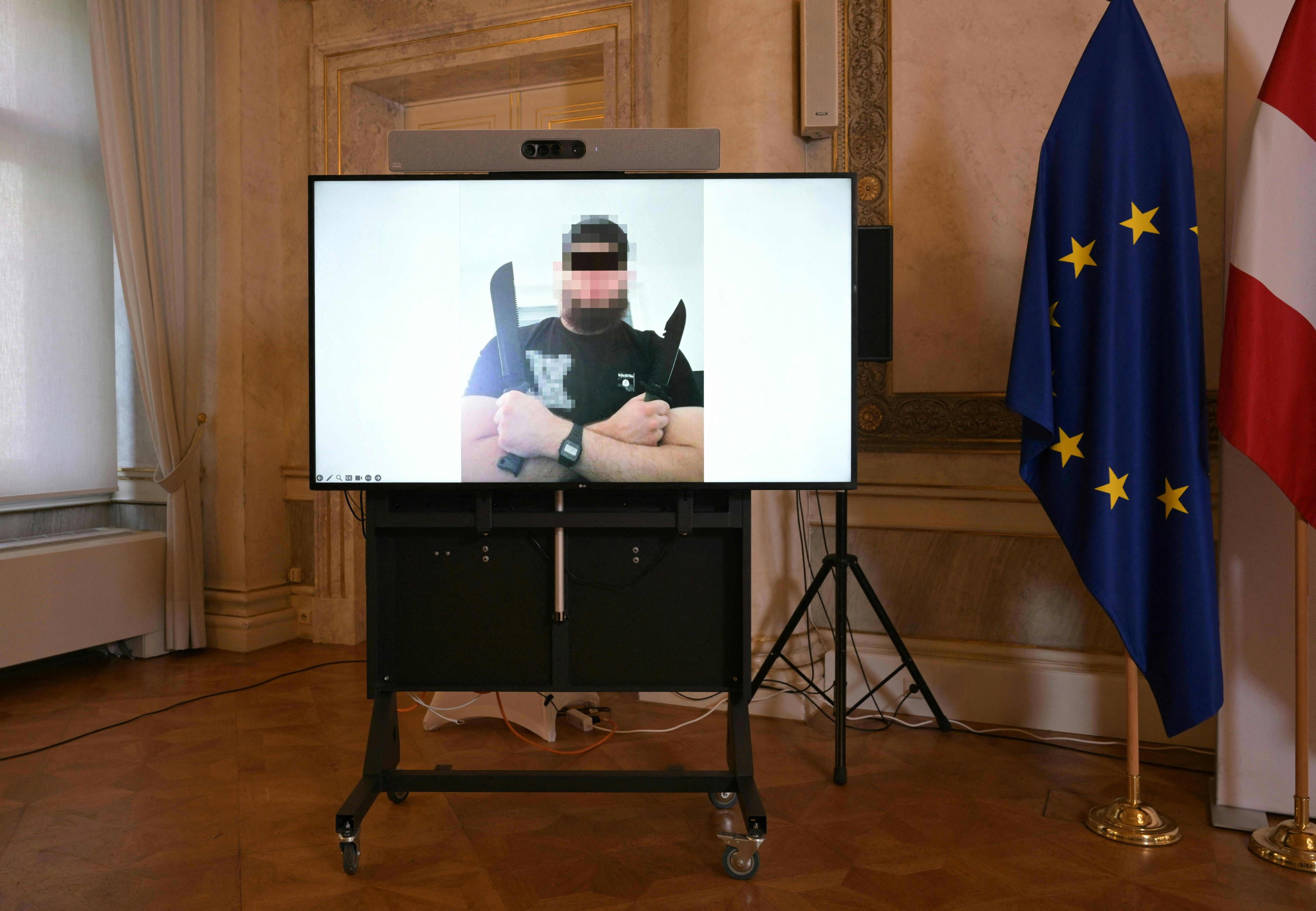 A screen displays a photo of a man arrested in connection with an Islamist attack plot in Vienna, Austria. Photo: AFP