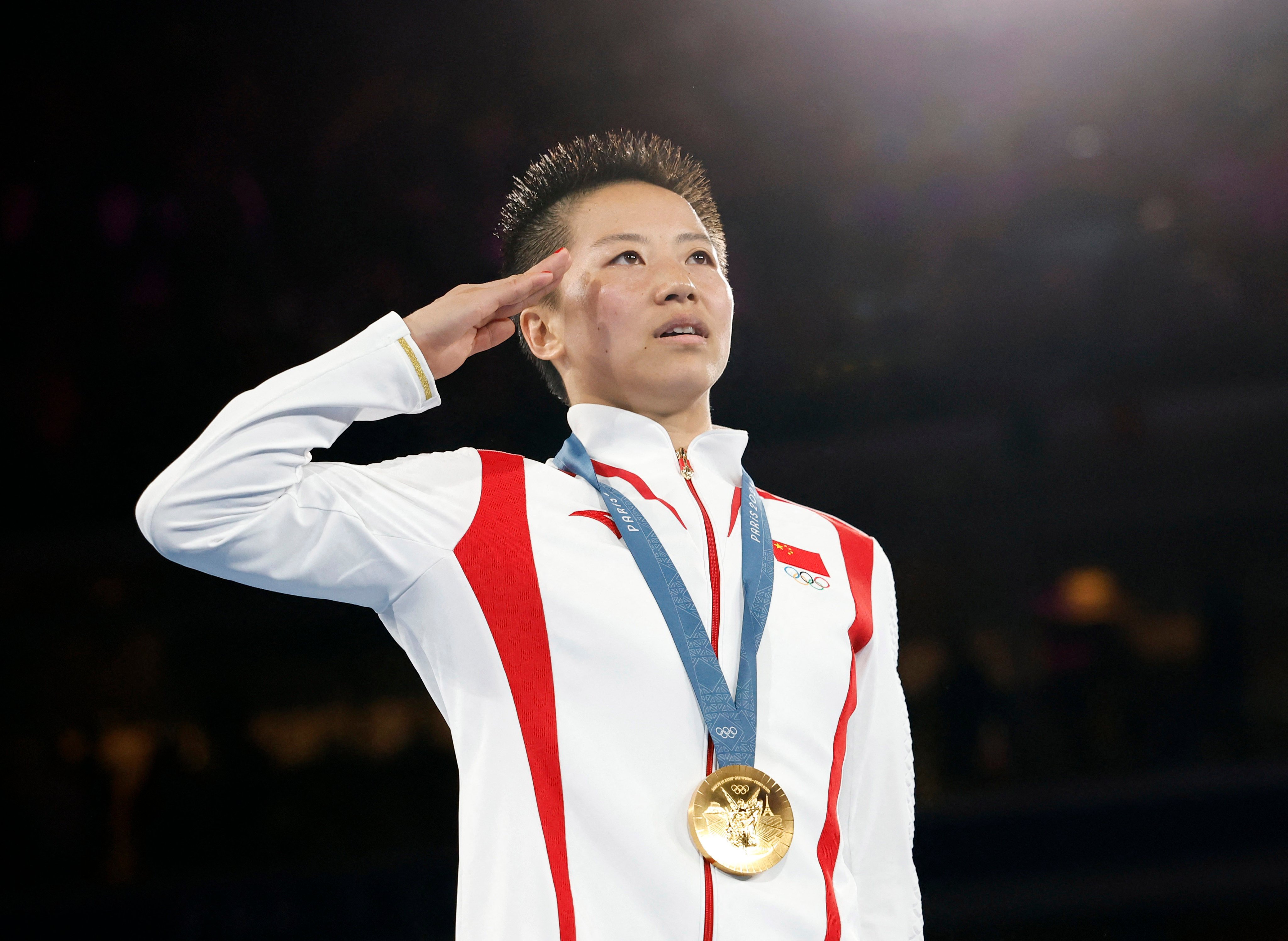 China gold medallist Wu Yu salutes her nation’s flag during the medal ceremony. Photo: Reuters