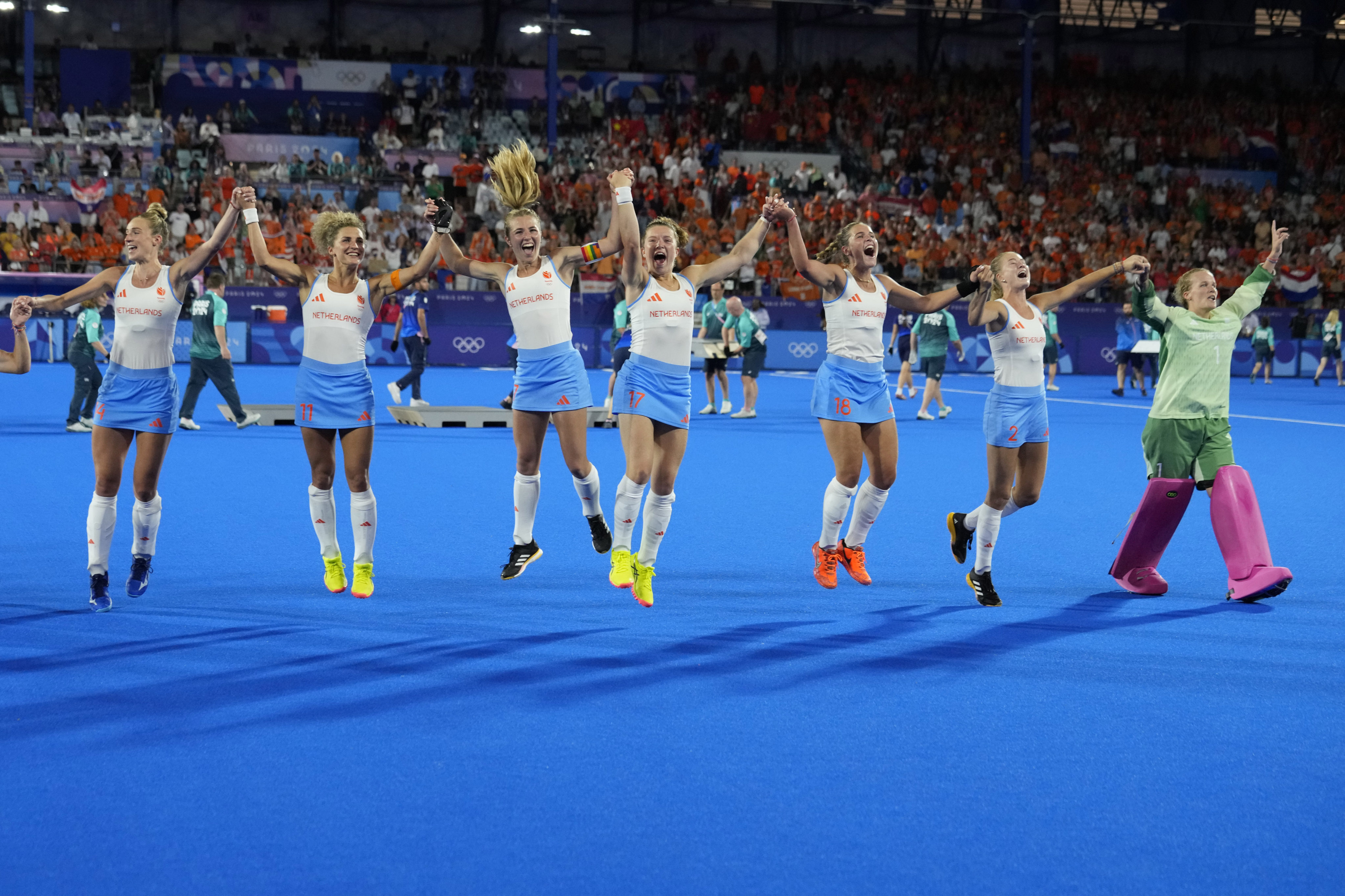 Netherlands’ goalkeeper Anne Veenendaal, right, and teammates celebrate after winning the women’s hockey gold medal match against China. Photo: AP