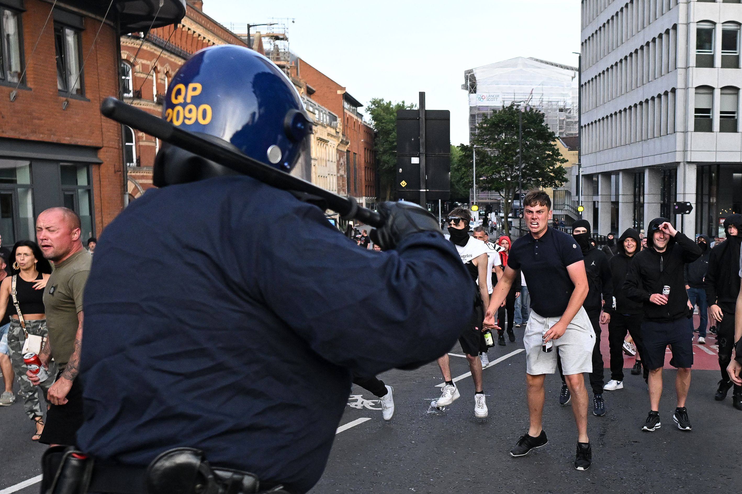 Riot police face protestors in Bristol, southern England, on August 3, 2024 during the ‘Enough is Enough’ demonstration held in reaction to the fatal stabbings in Southport on July 29. Photo: AFP