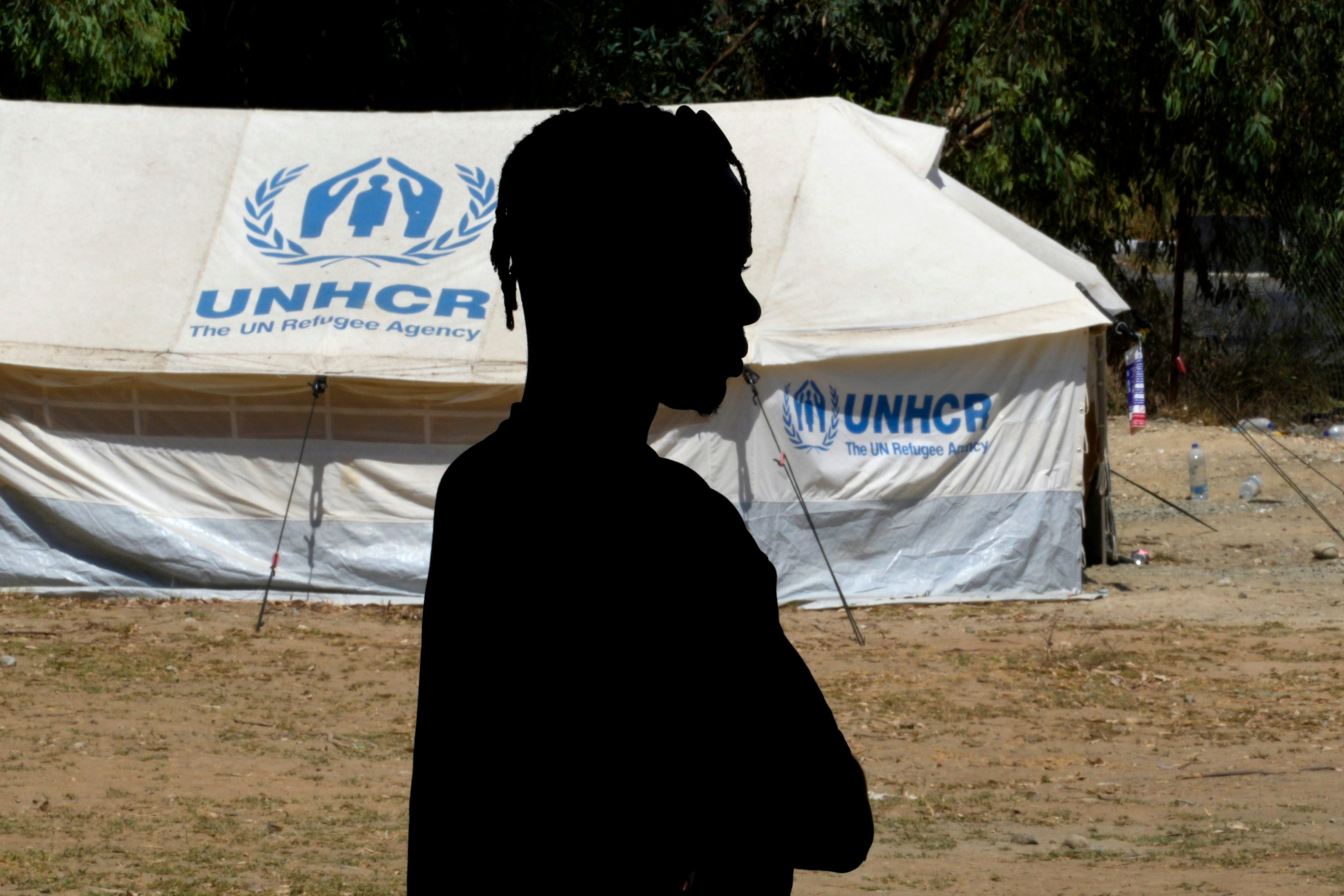 A refugee stands in front of a tent at a camp inside the UN-controlled buffer zone that divides the north part of the Turkish-occupied area from the south Greek Cypriots at the Aglantzia area in Nicosia, Cyprus, on August 9. In a world where developed economies face dire demographic challenges, international migrants are likely to play a key role in continued economic growth. Photo: AP