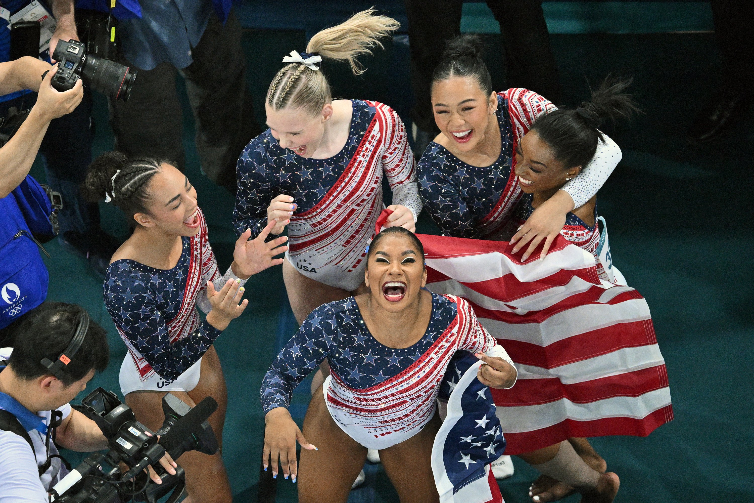 US gymnasts Simone Biles (right), Sunisa Lee (left), Jordan Chiles (front), Jade Carey (back) and Hezly Rivera celebrate after winning the artistic gymnastics women’s team final. Photo: TNS