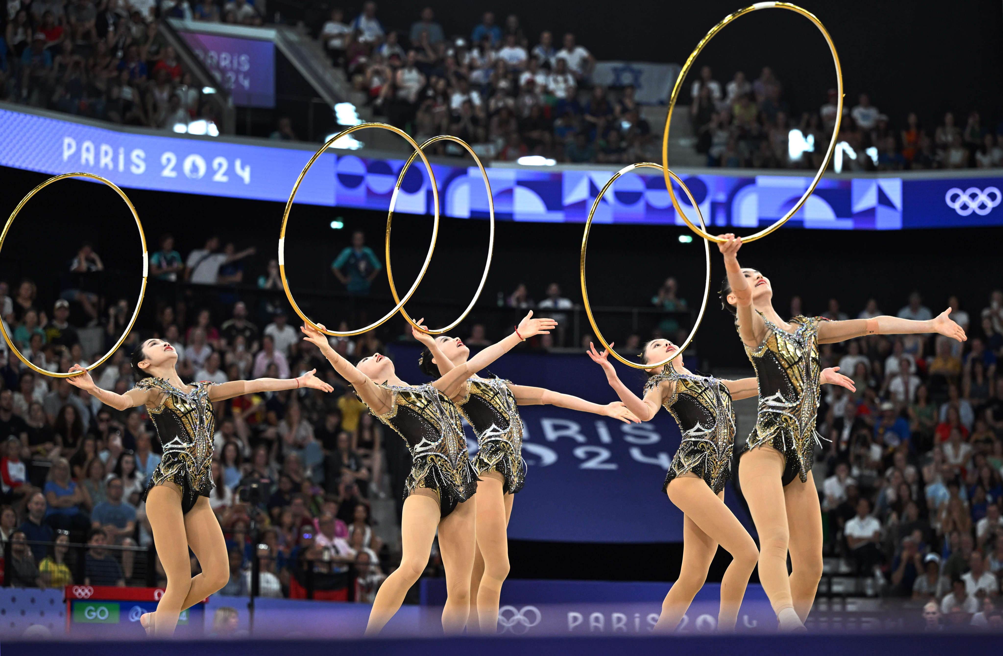 The five-woman Chinese team posted a total of 69.800 points in the final, which had two routines: one using hoops, the other using ribbons and balls. Photo: Xinhua