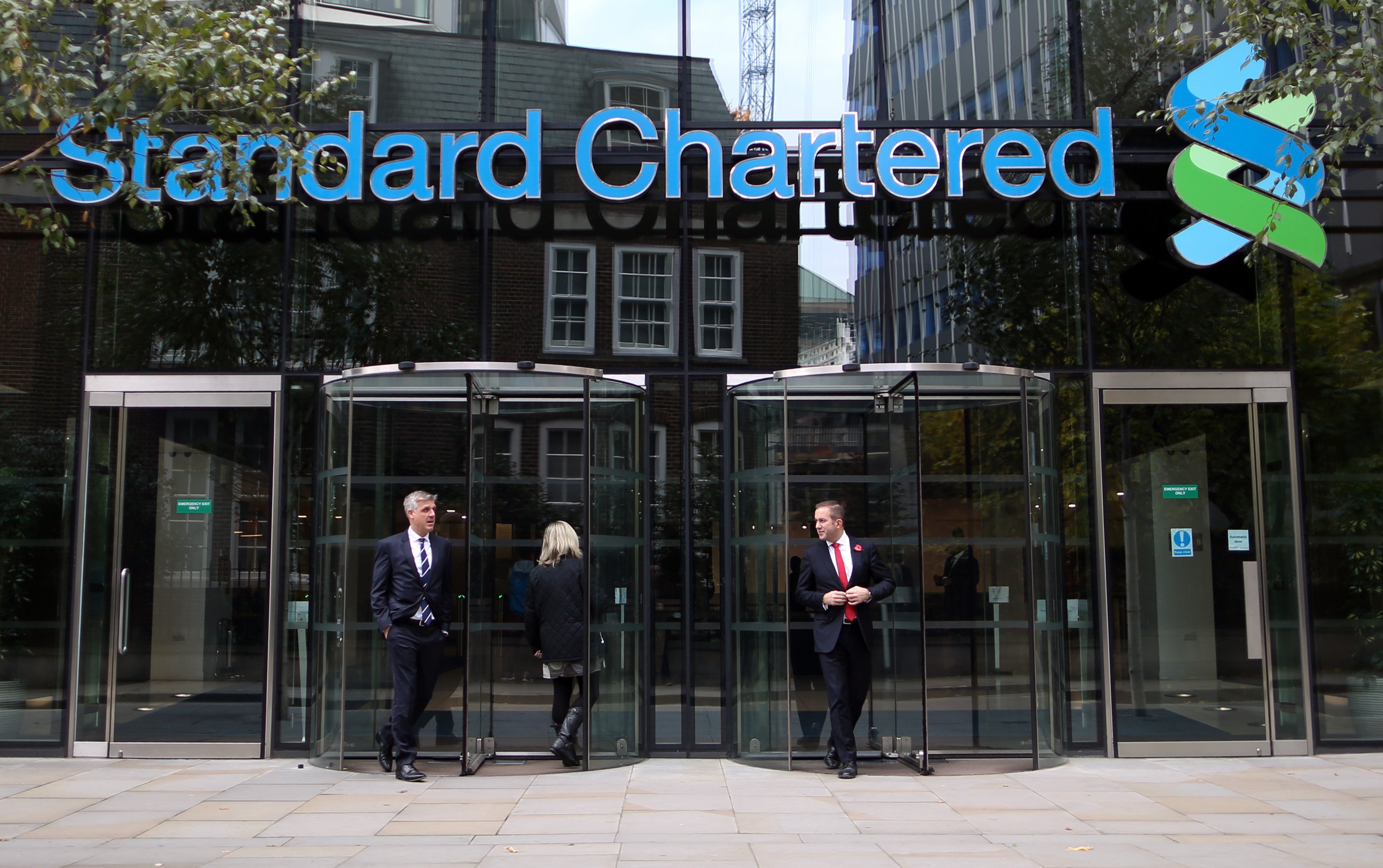 Visitors leave the headquarters of Standard Chartered in London. Photo: Bloomberg 