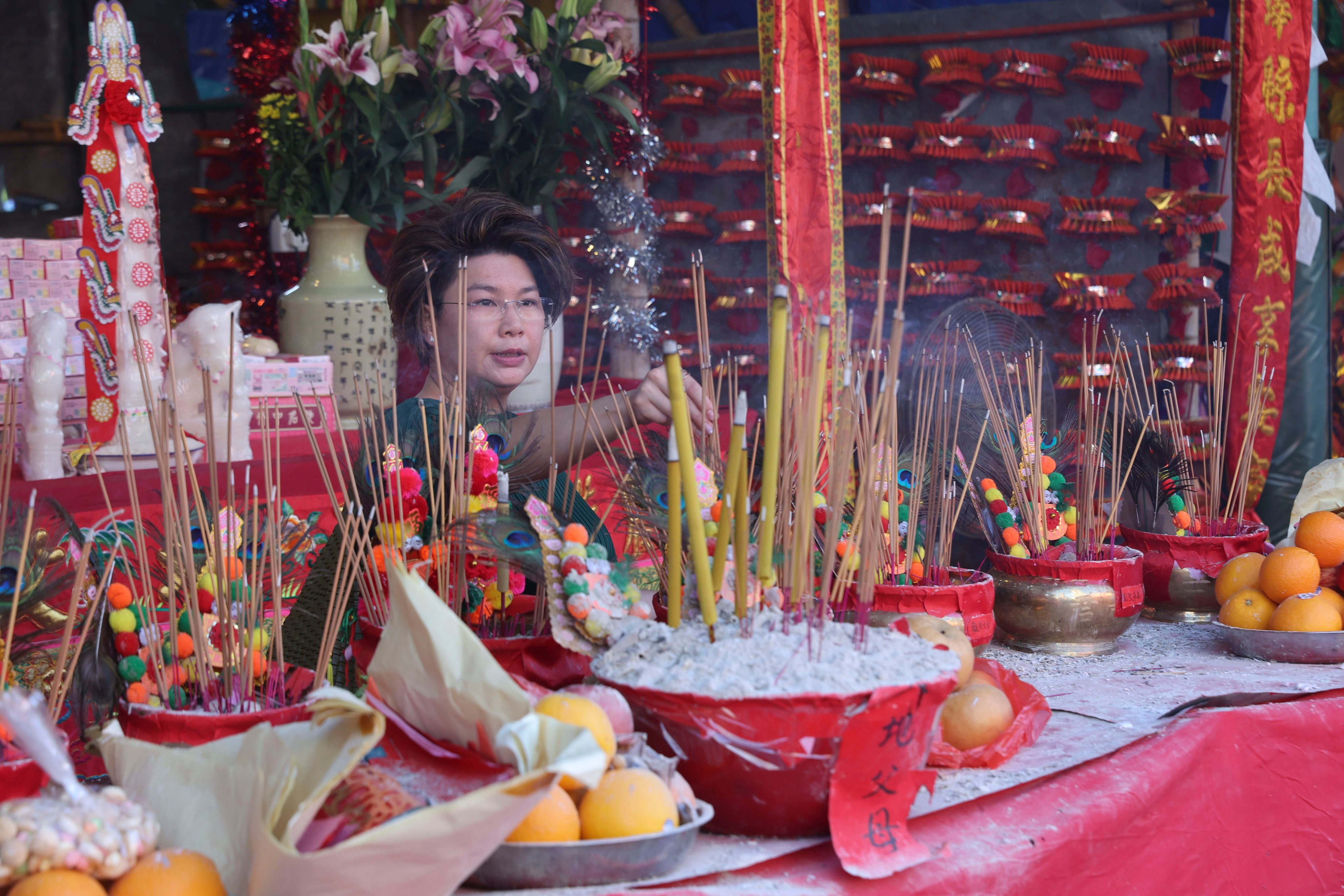 A woman burns incense for the Hungry Ghost Festival at Carpenter Road Park, Kowloon City. Photo: Edmond So