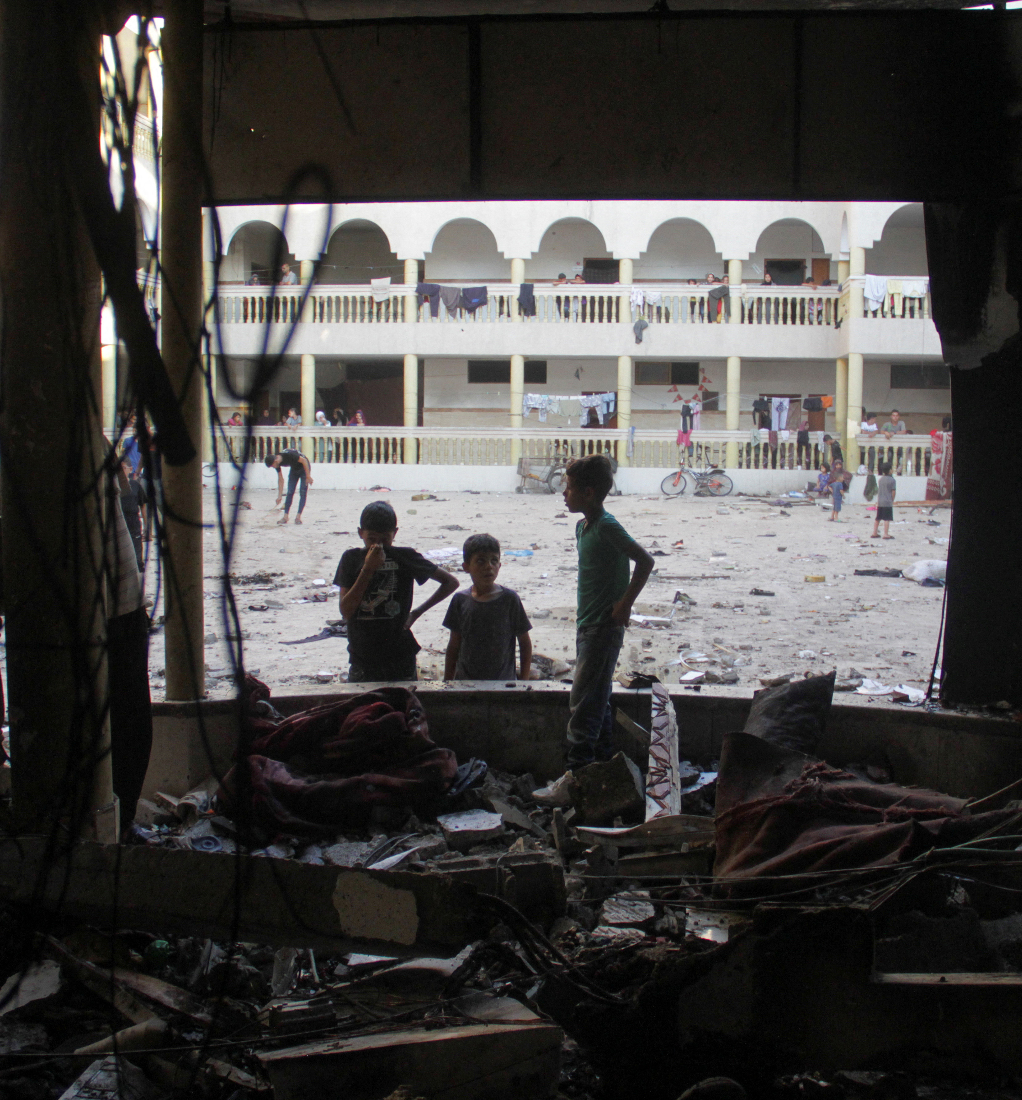 Palestinians look at the damage at the site of an Israeli strike on a school sheltering displaced people in Gaza on August 10, 2024. Photo: Reuters