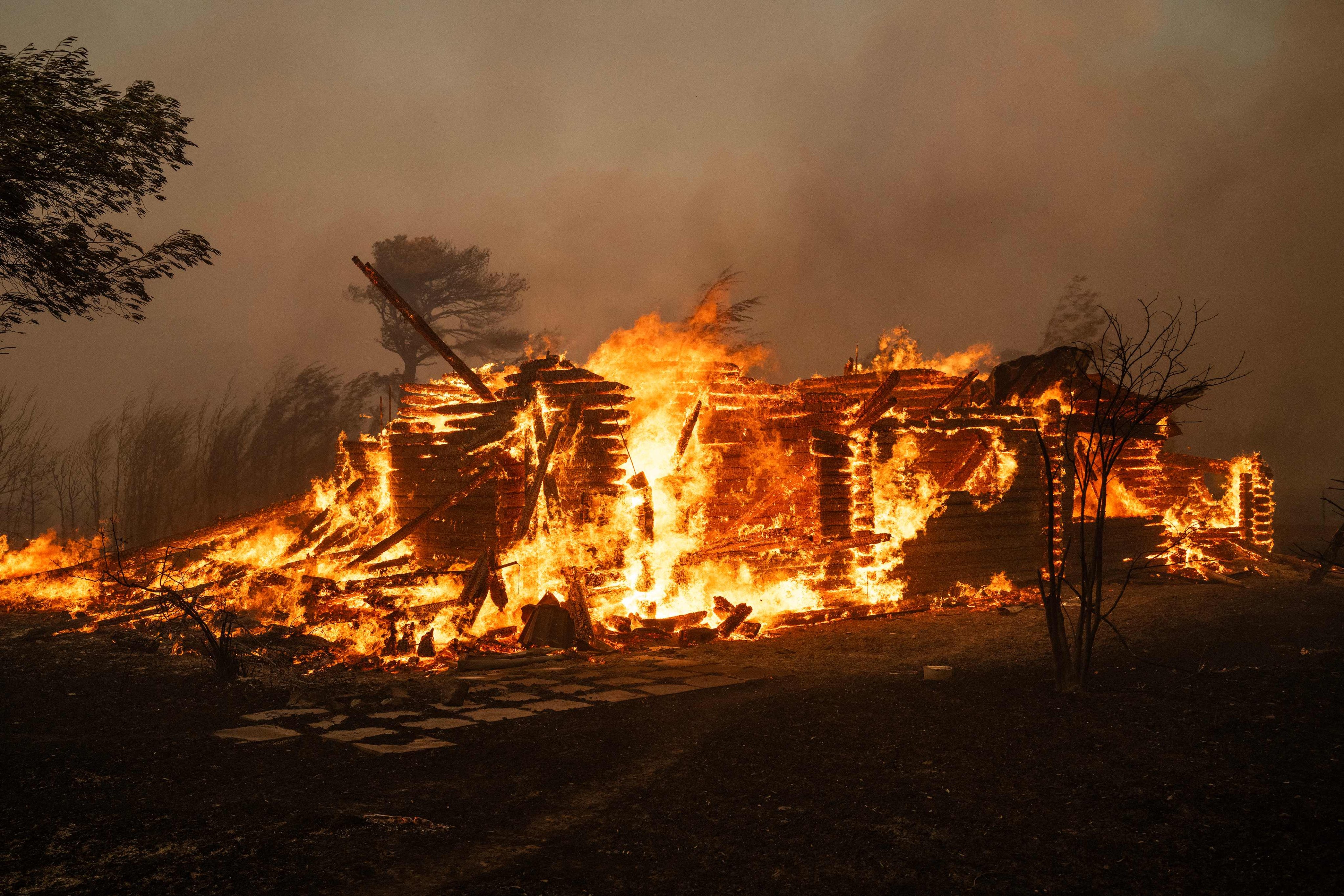 A house burns during a wildfire in Varnavas, north of Athens, Greece on Sunday. Photo: AFP