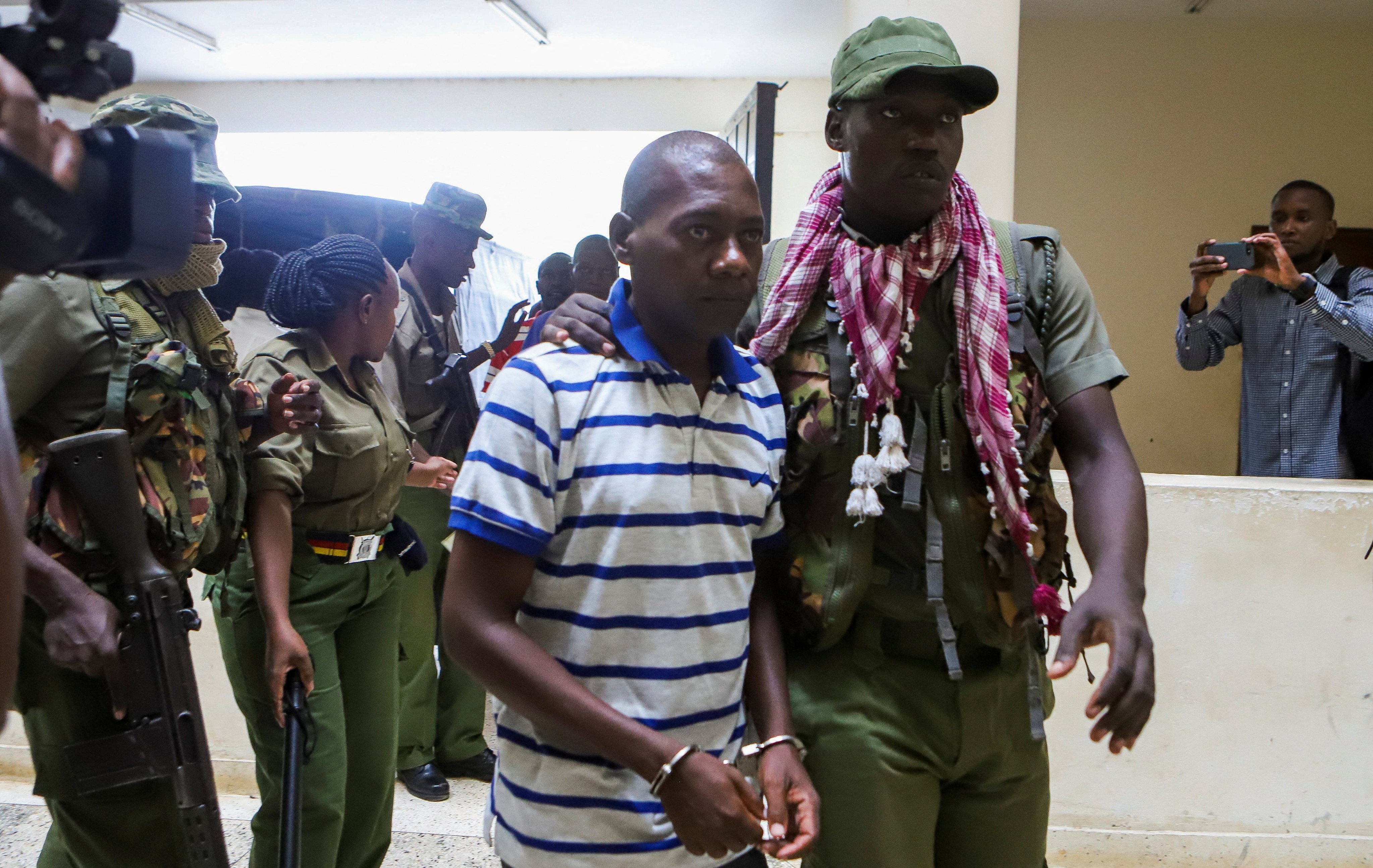 Paul Mackenzie, a Kenyan cult leader accused of ordering his followers to starve themselves to death in Shakahola forest, is escorted to the law courts in Malindi. Photo: Reuters