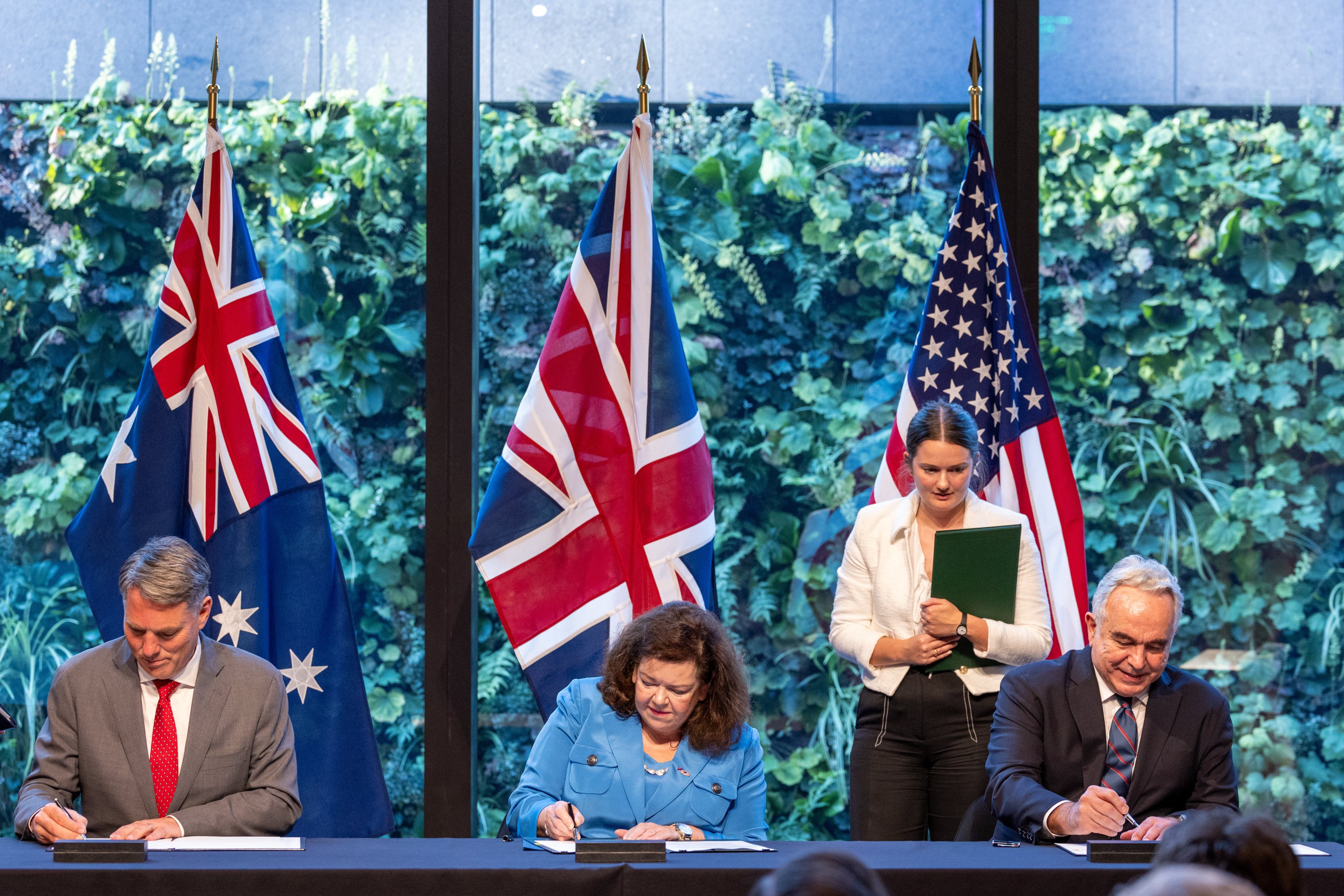 Australia’s Deputy Prime Minister and Minister for Defence Richard Marles, British Ambassador to the USA Karen Pierce and US Deputy Secretary of State Kurt Campbell sign the Aukus agreement for cooperation related to naval nuclear propulsion in Washington DC, on August 5. Photo: Australia’s government