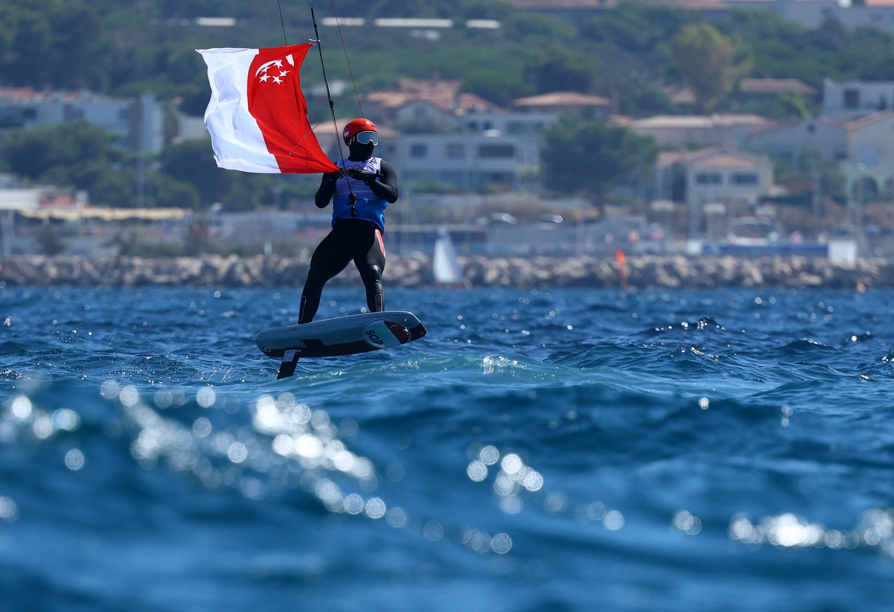 Singapore’s Maximilian Maeder celebrates winning the bronze medal in kitefoiling at the Paris 2024 Olympics. Photo: Reuters