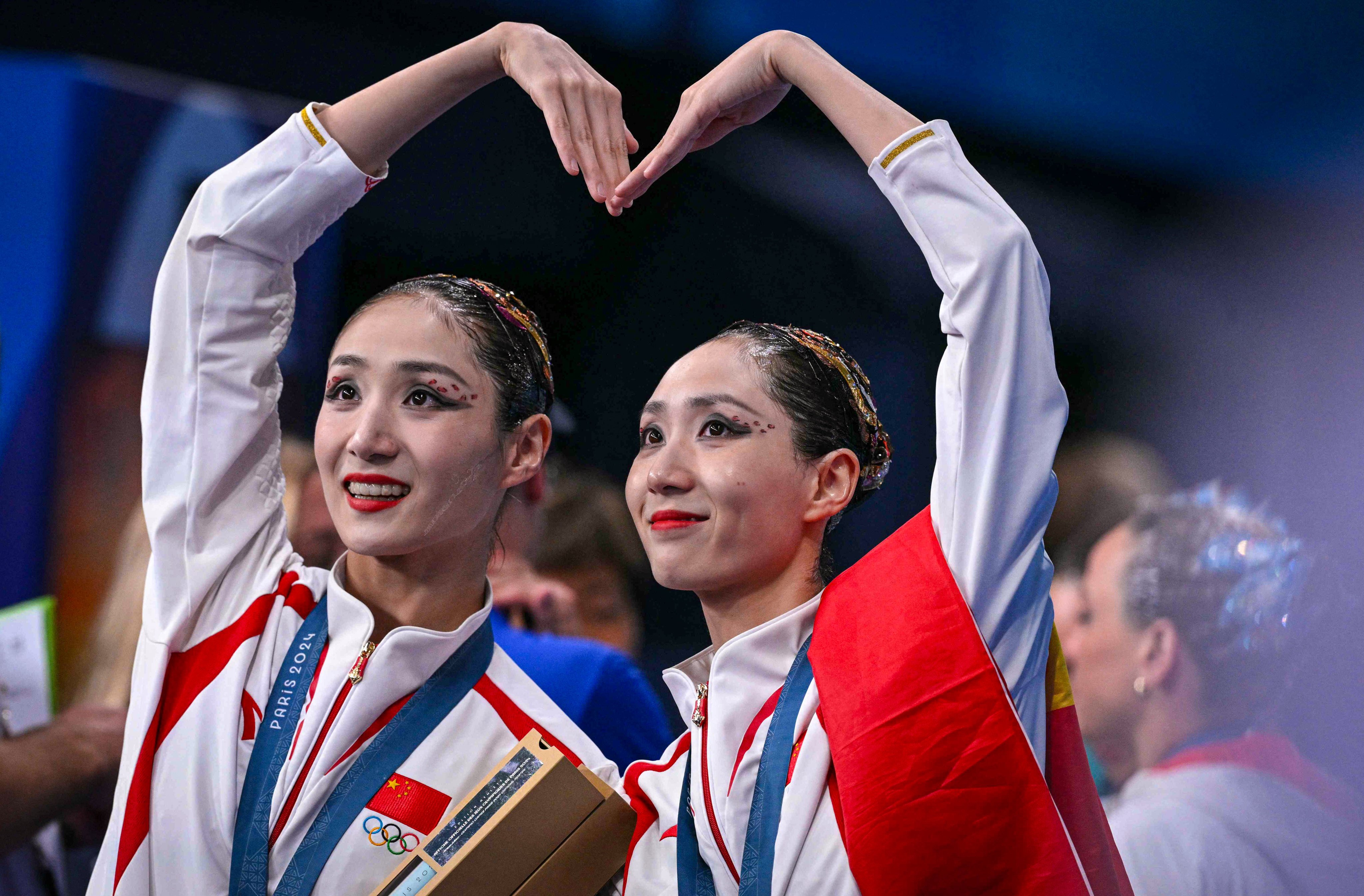 Gold medallists Wang Liuyi and Wang Qianyi celebrate after securing gold in Paris. Photo: AFP