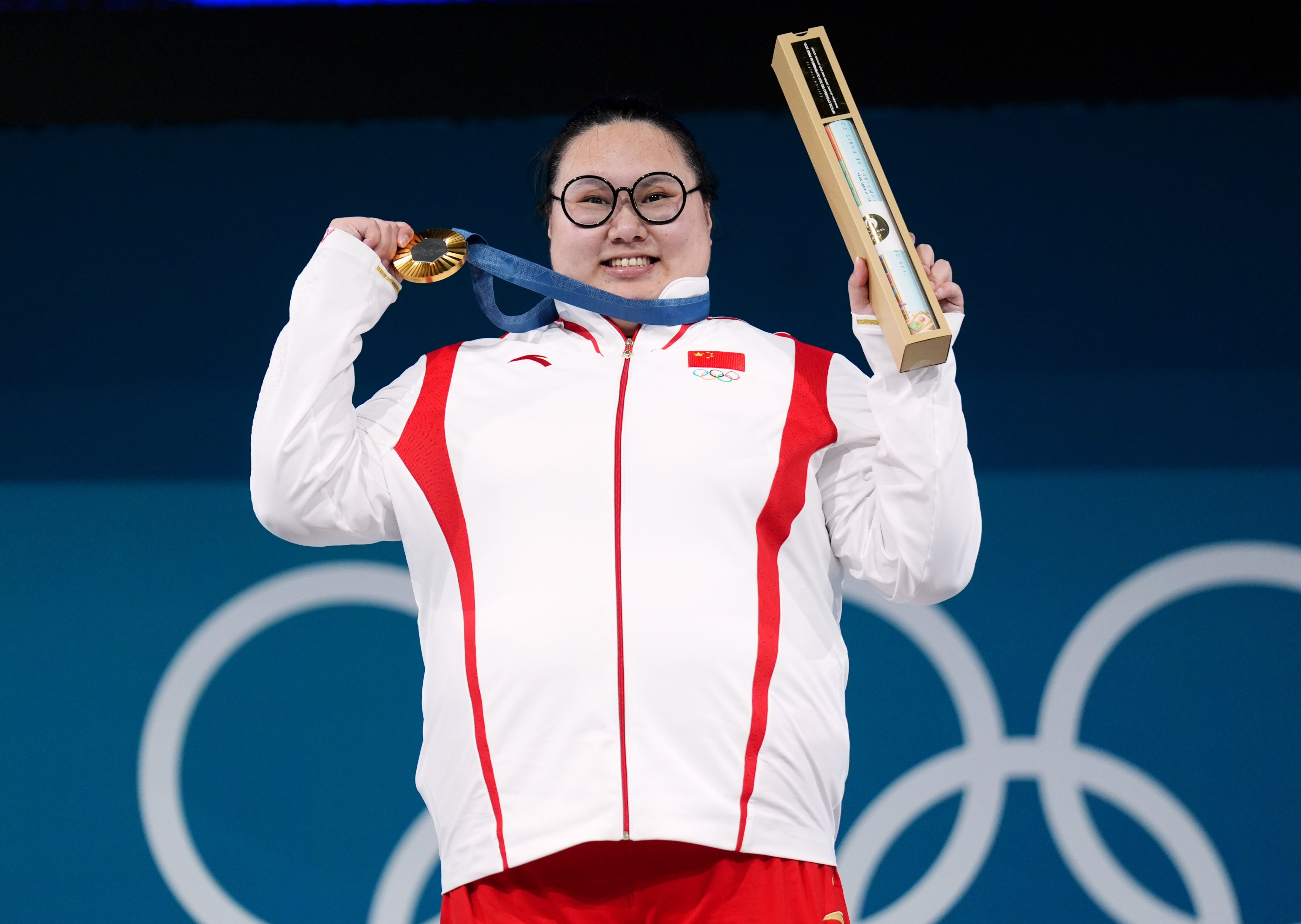 China’s Li Wenwen celebrates gold in the women’s +81kg weightlifting on the final day of the Games. Photo: dpa