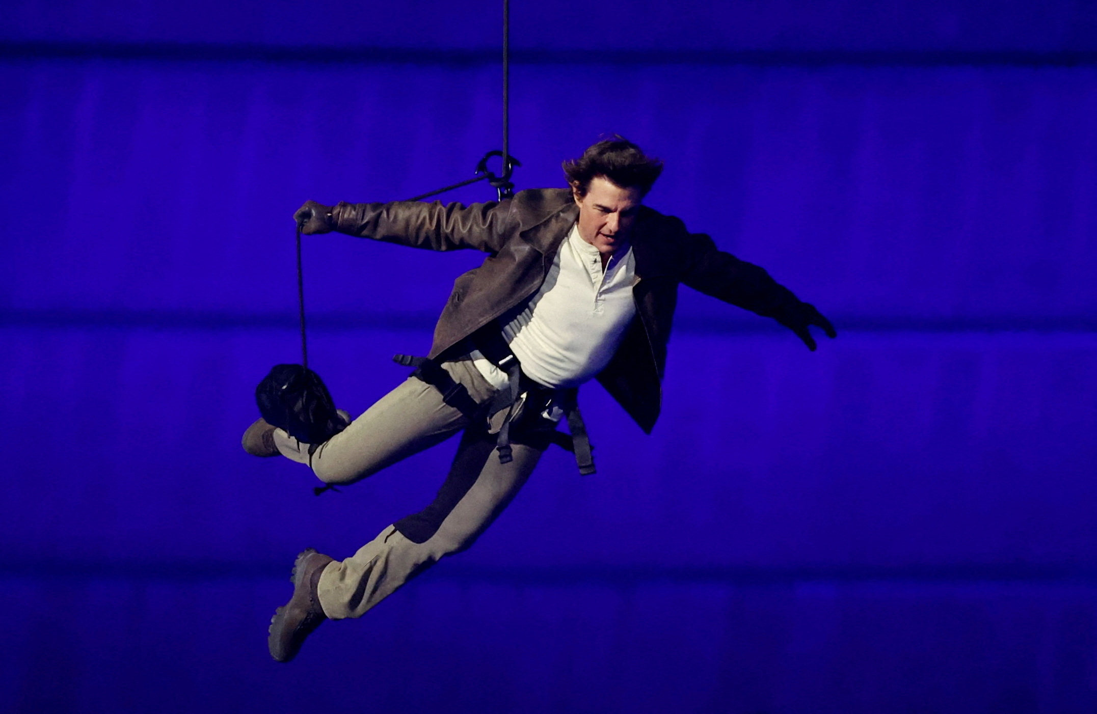 Actor Tom Cruise jumps from the roof of the Stade de France during the closing ceremony. Photo: Reuters