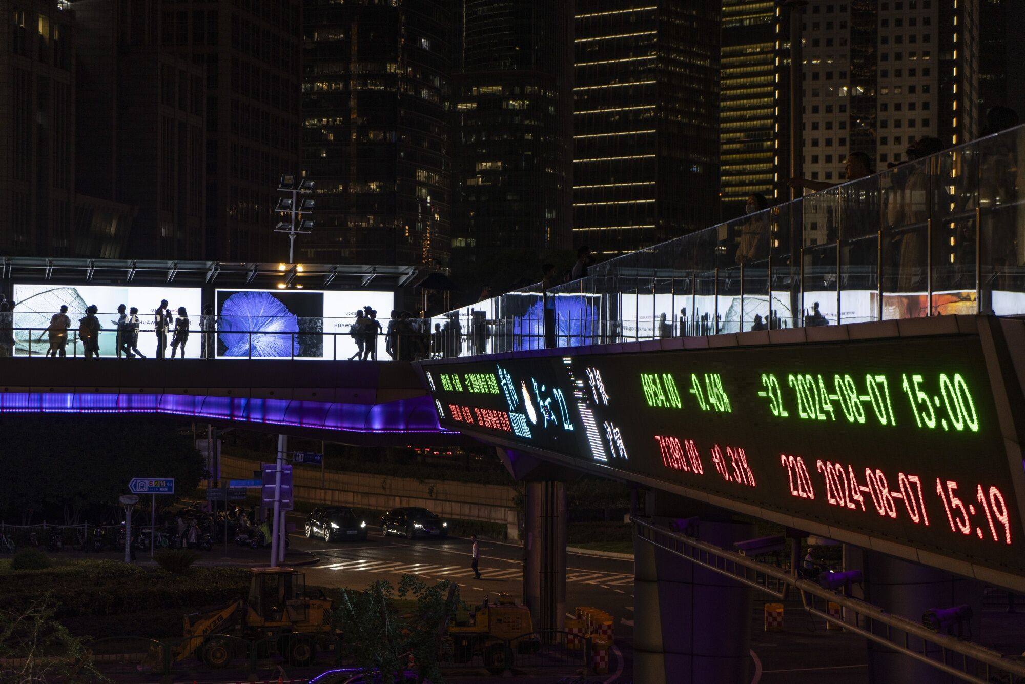 An electronic ticker displays stock figures in Shanghai on Wednesday, August 7. Photo: Bloomberg