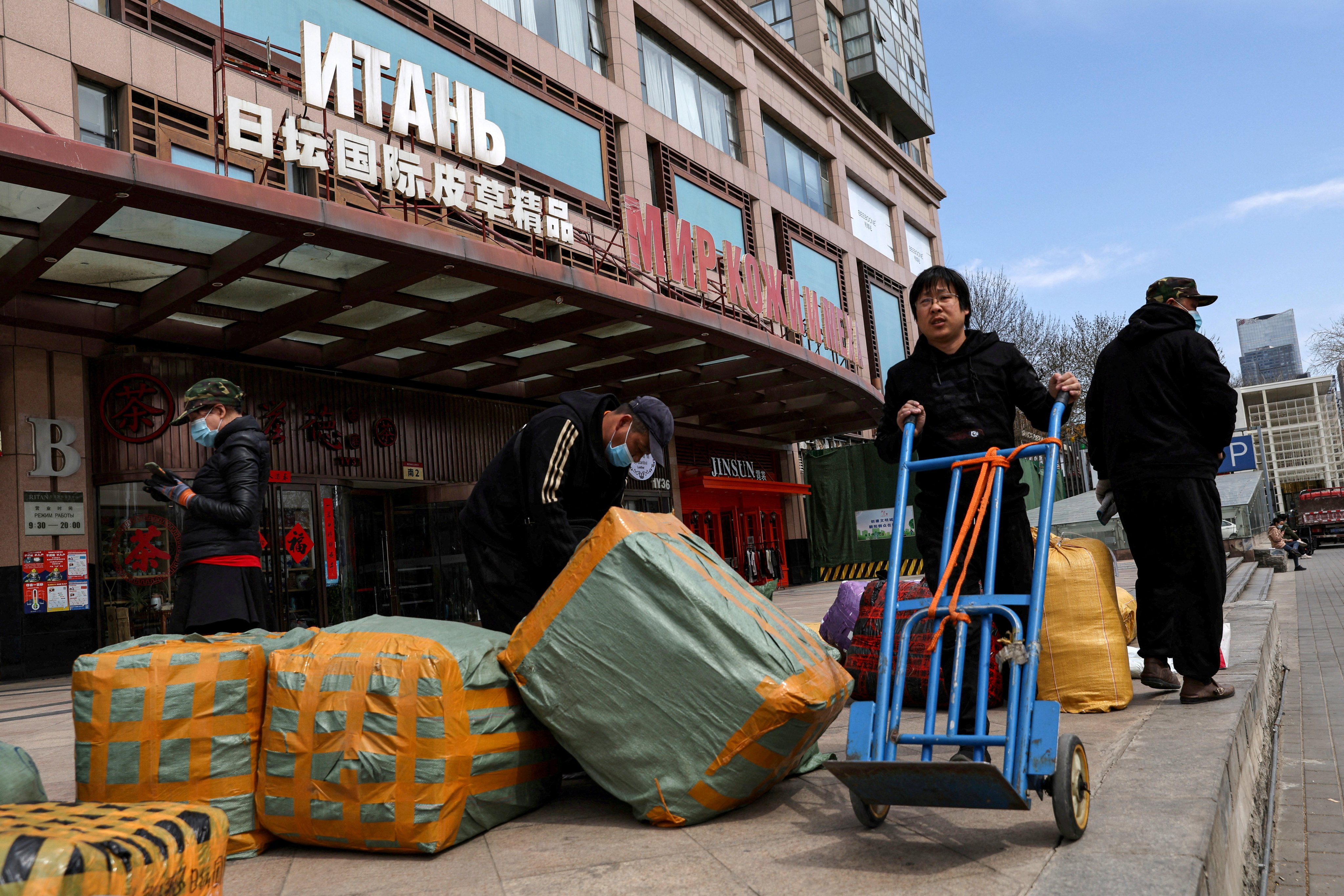 Workers move bundles of goods for export at a Beijing trading centre that houses shops and offices with Russian goods and services. Photo: Reuters