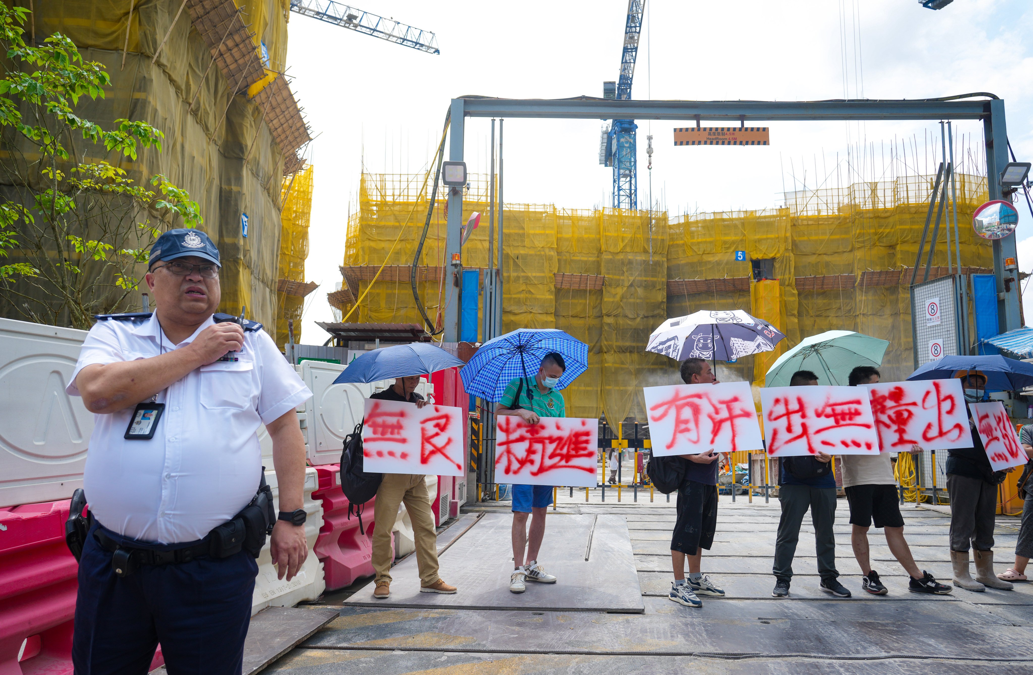 Protesting workers block the entrance to the construction site over unpaid wages. Photo: Sam Tsang