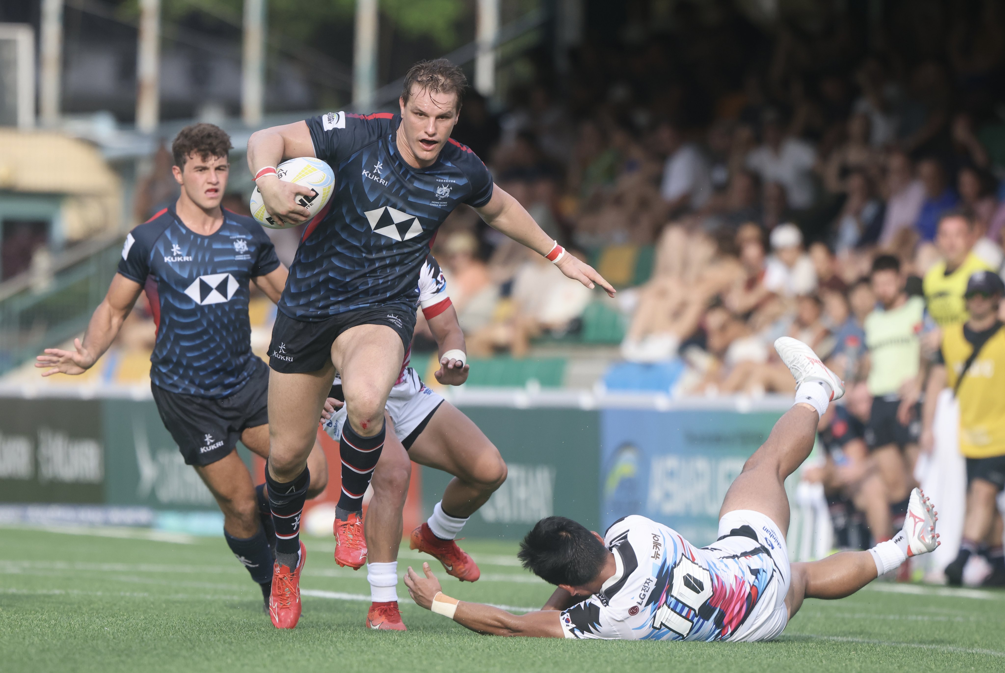 Hong Kong’s Tommy Hill skips past South Korea’s Jung Bu-hyon during the final of the 2024 Asia Rugby Championship at Football Club. Photo: Jonathan Wong