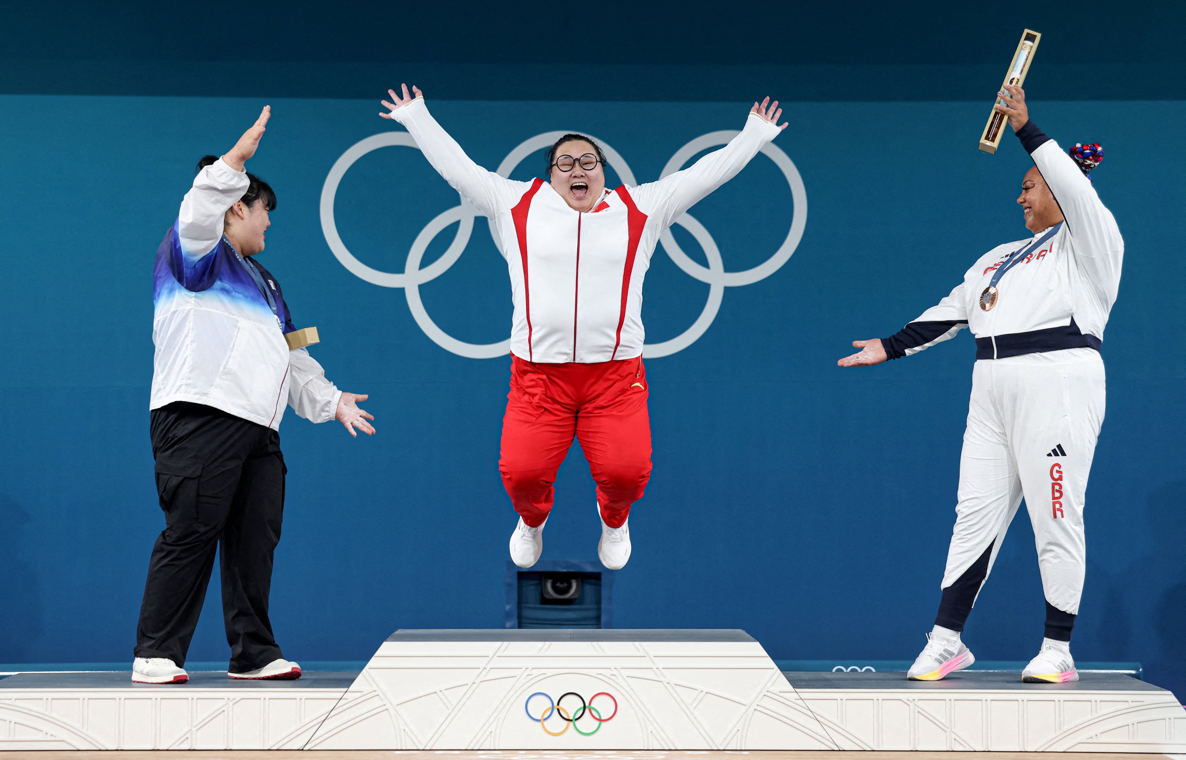 Women’s +81kg weightlifting gold medallist Wenwen Li (centre) of China celebrates on the podium with silver medallist Park Hye-jeong (left) of South Korea and bronze medallist Emily Campbell of Britain at the South Paris Arena in Paris on August 11. Photo: Reuters