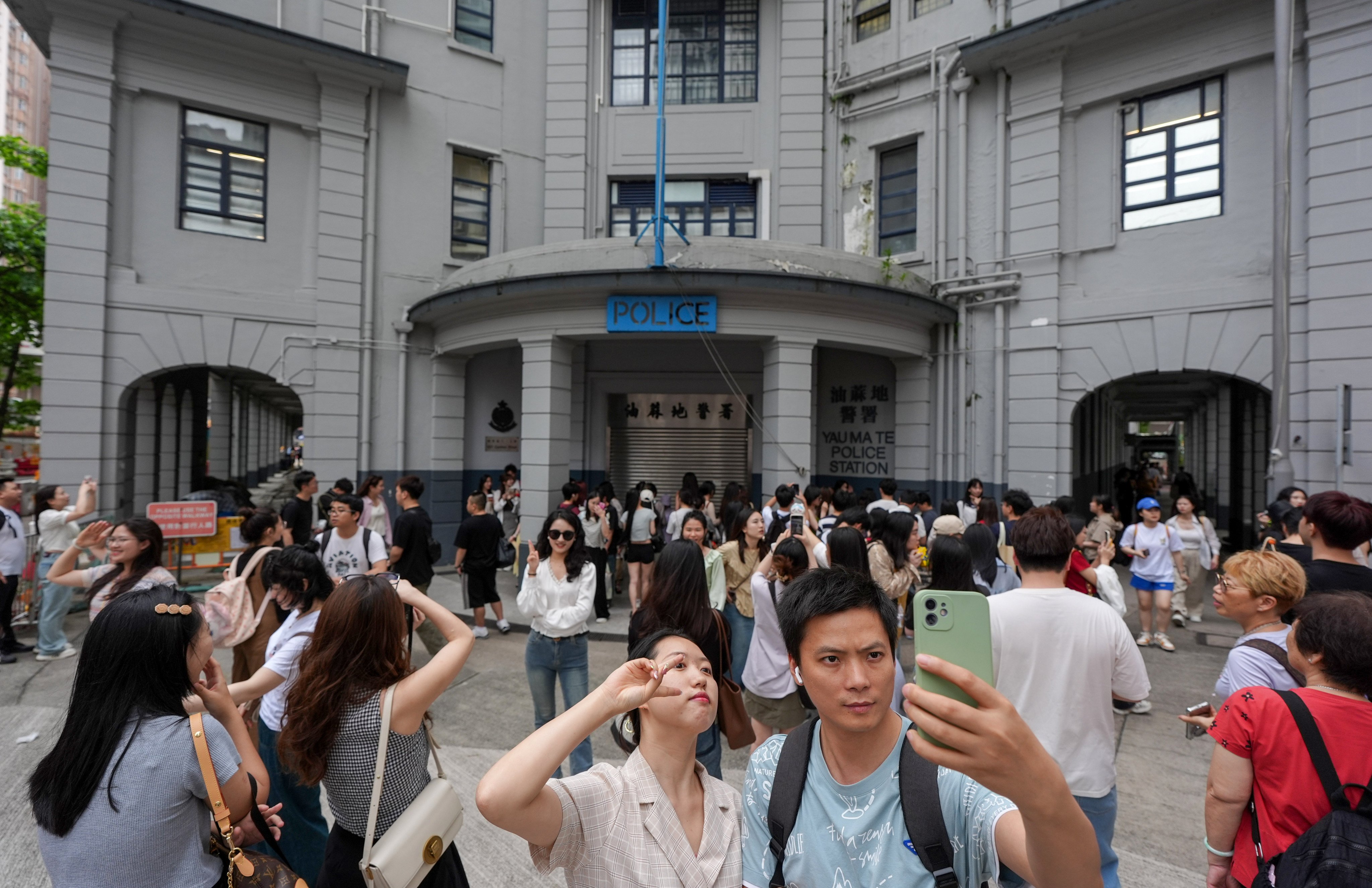 Tourists take photos at the former Yau Ma Tei police station on May 2, as the spot trends on Xiaohongshu, the social media platform. Photo: Eugene Lee 