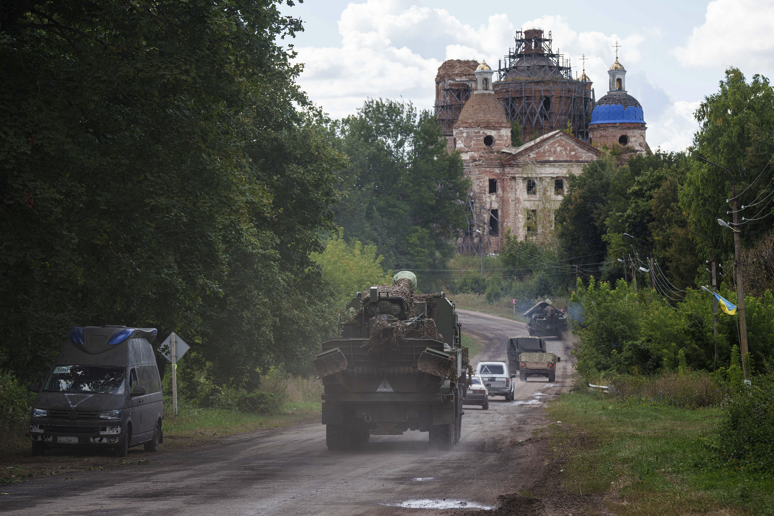 Military vehicles drive near the Russian border in Ukraine’s Sumy region on Tuesday. Photo: AP