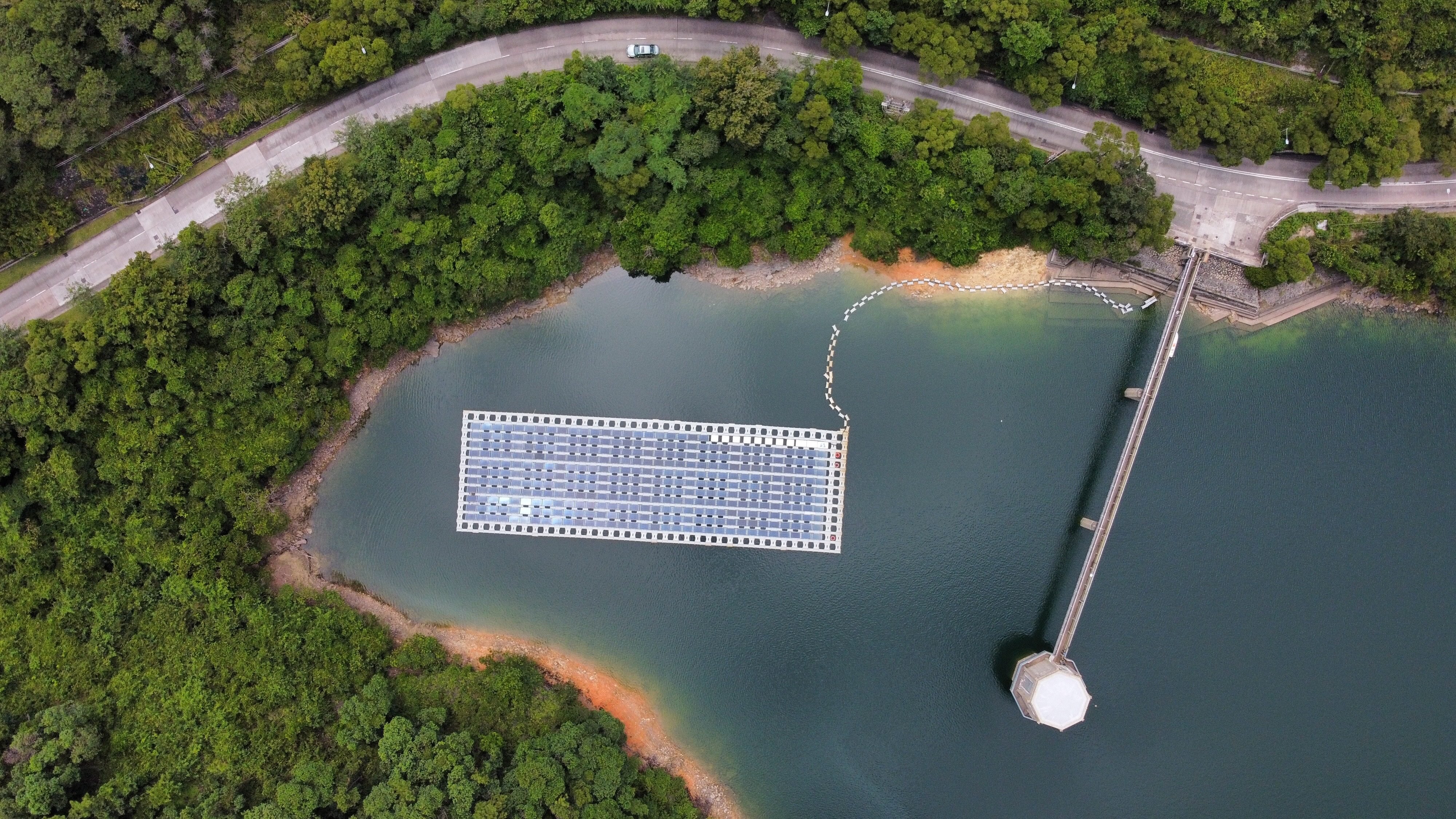 A photovoltaic system installed by the Water Supplies Department floats at the Shek Pik Reservoir to collect reference data for the future implementation of large-scale floating solar farms on reservoirs in Hong Kong, in September 2021. Photo: Martin Chan