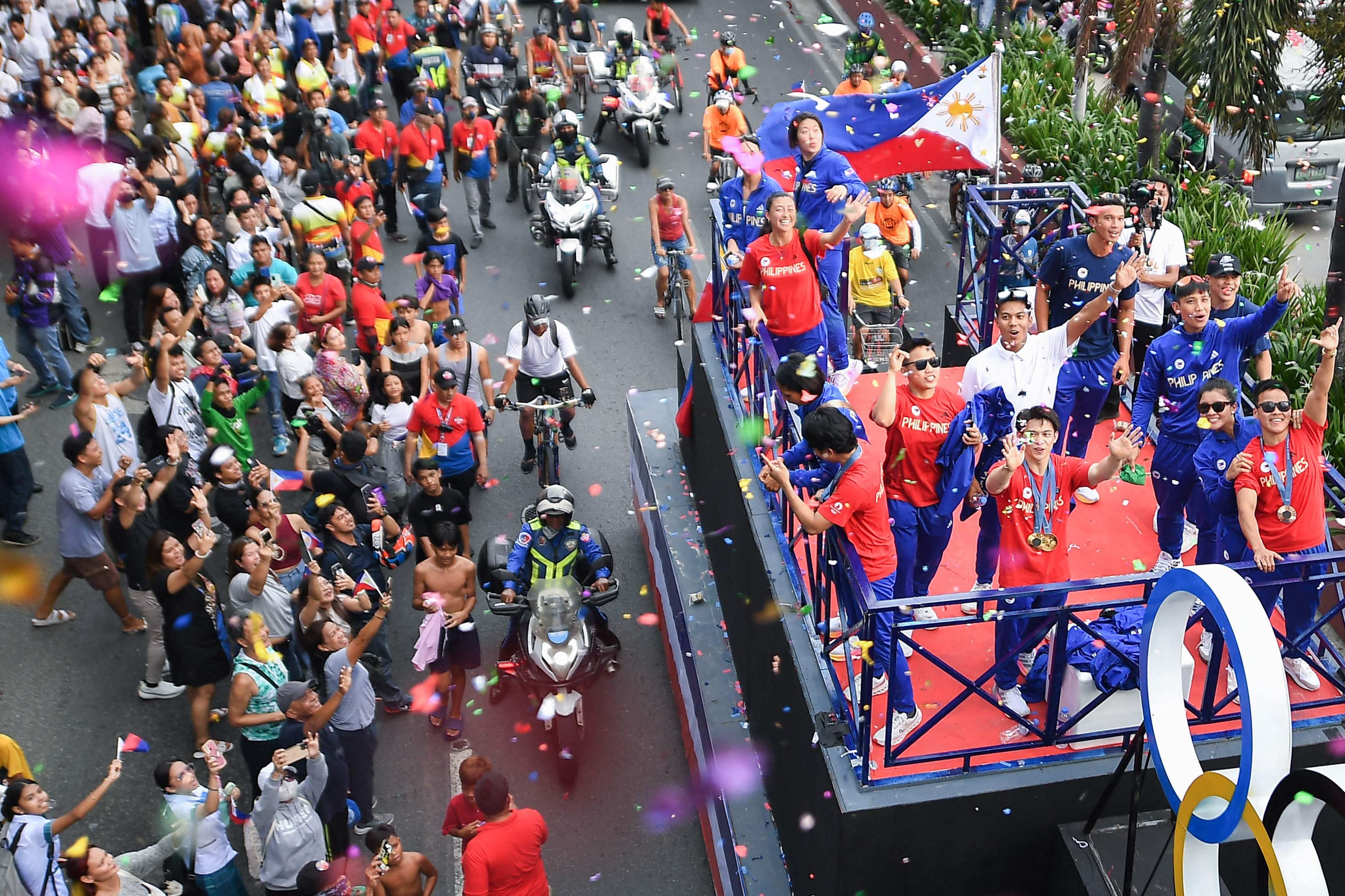 Carlos Yulo (centre, front on float) and other Filipino athletes who competed in Paris, taking part in a homecoming parade along the streets of Manila on Wednesday. Photo: AFP