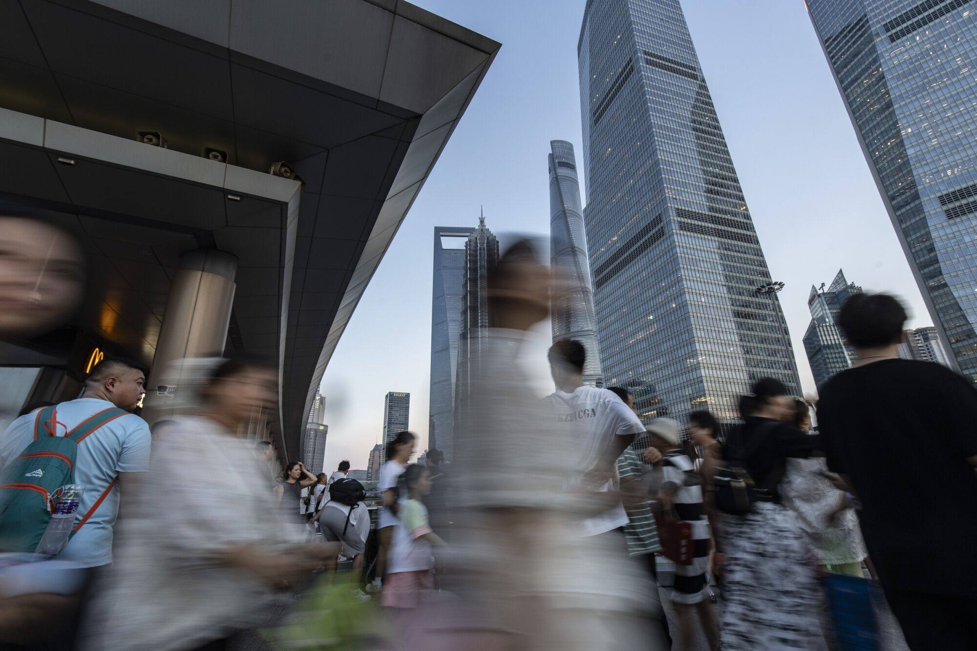 Pedestrians in Pudong’s Lujiazui Financial District in Shanghai, China. Photo: Bloomberg