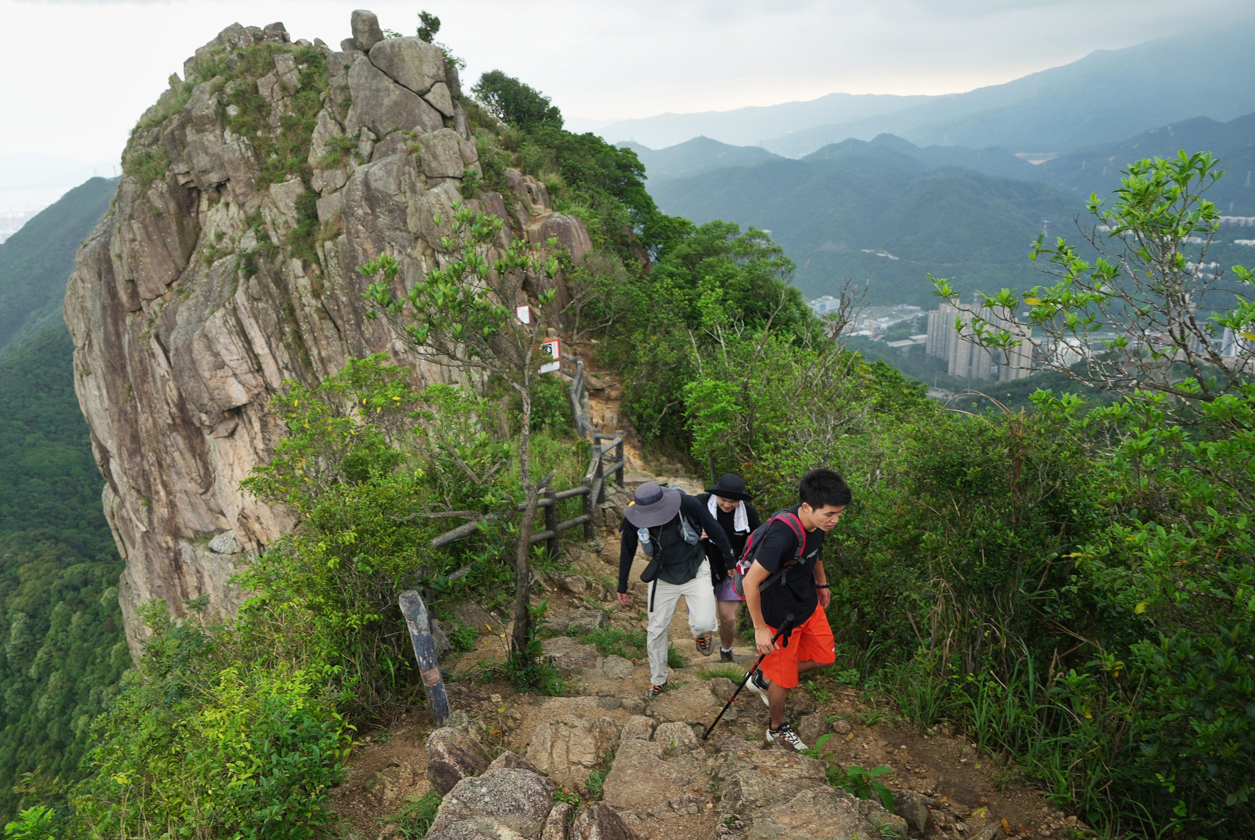 Tourists take in the view after hiking to Lion Rock Peak. Photo: Elson Li