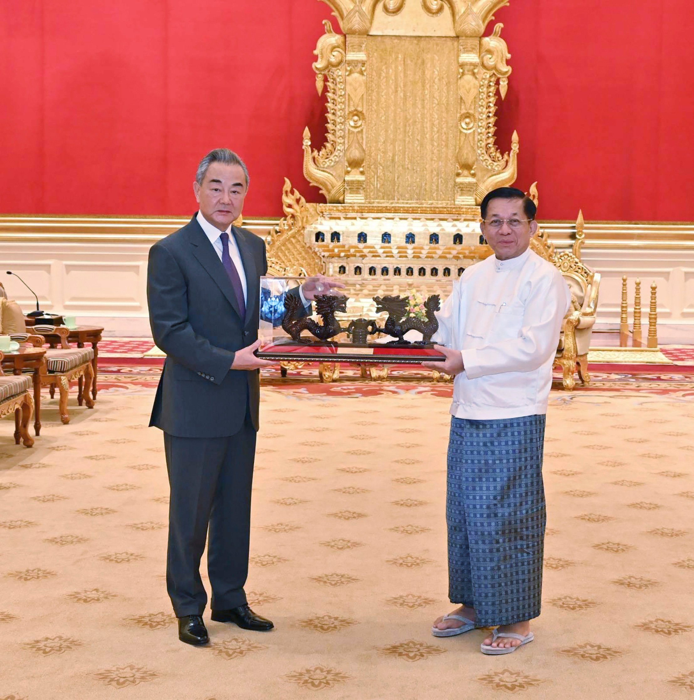 Myanmar’s military leader Senior General Min Aung Hlaing (right), chairman of the State Administration Council, exchanges gifts with Chinese Foreign Minister Wang Yi during their meeting on Wednesday in Naypyidaw. Photo: Myanmar Military True News Information Team via AP